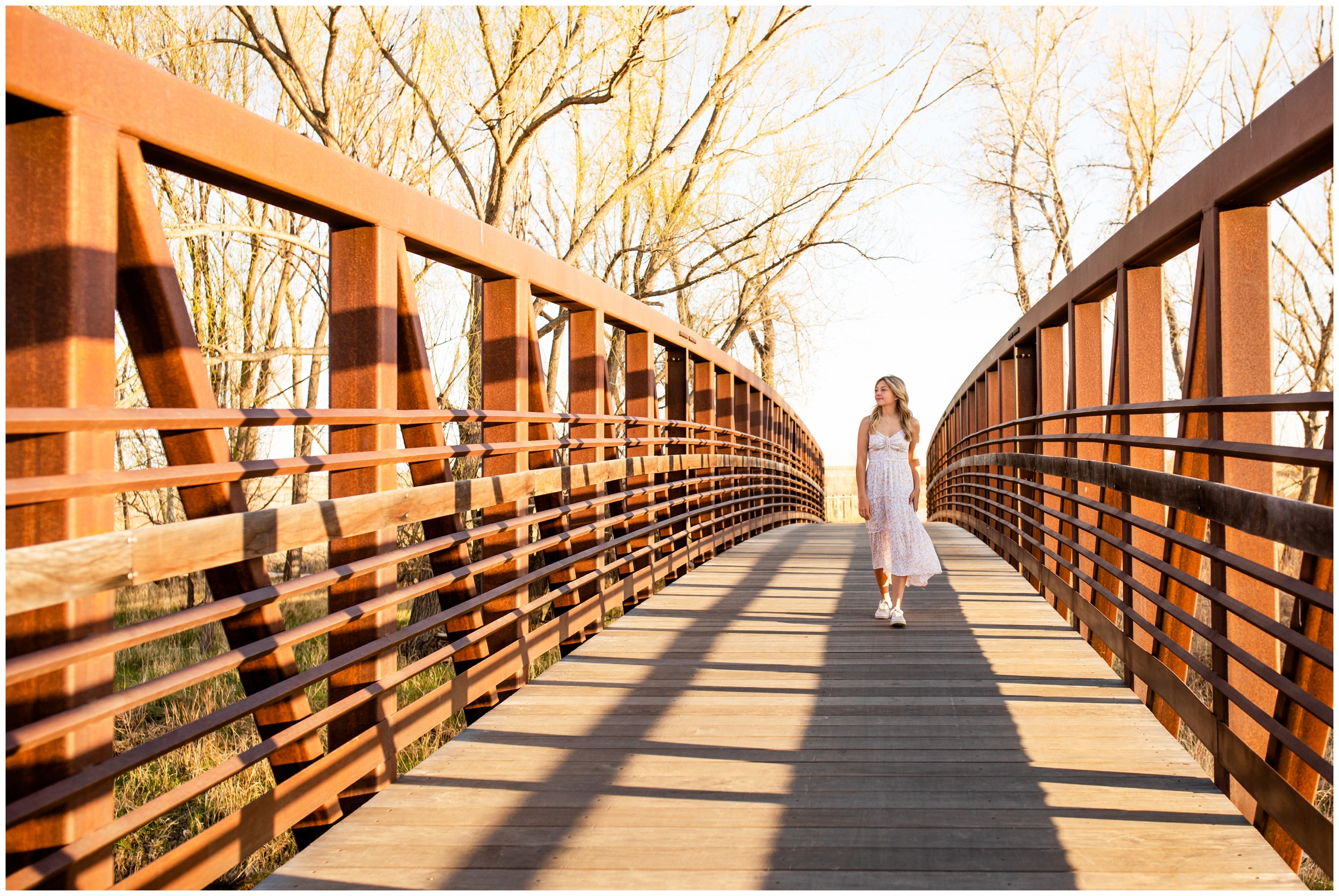 teen walking across bridge during Longmont high school graduation portraits at Sandstone Ranch 