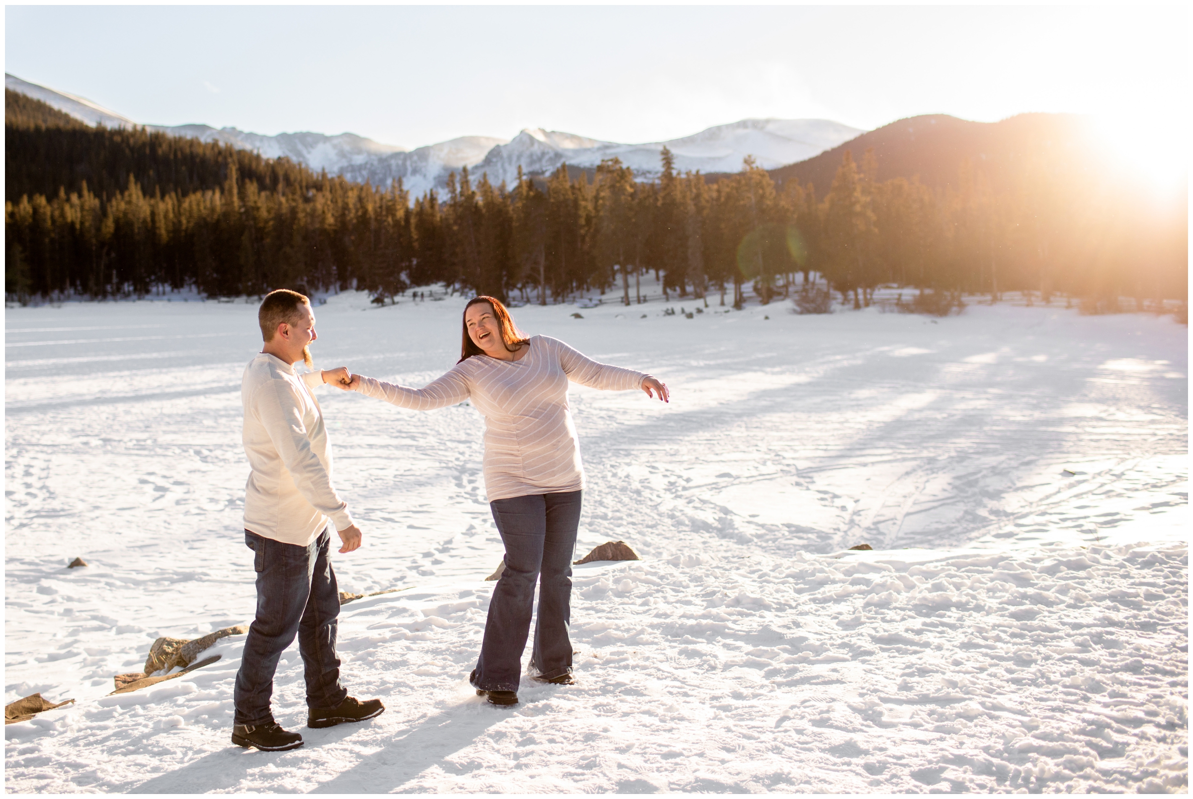 couple dancing on frozen lake during Echo Lake Colorado winter engagement pictures 