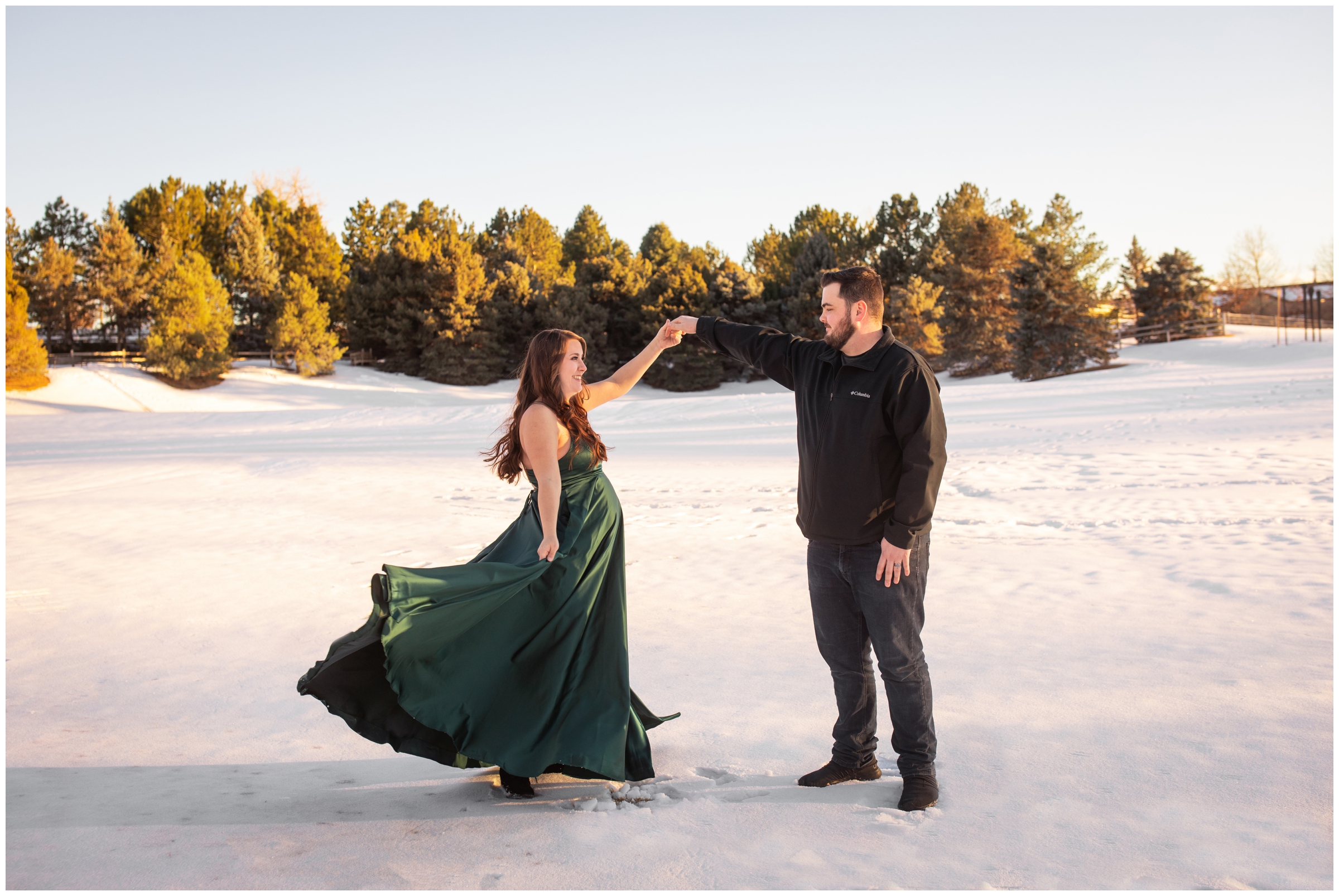 couple dancing in the snow during winter maternity pictures in Denver Colorado 