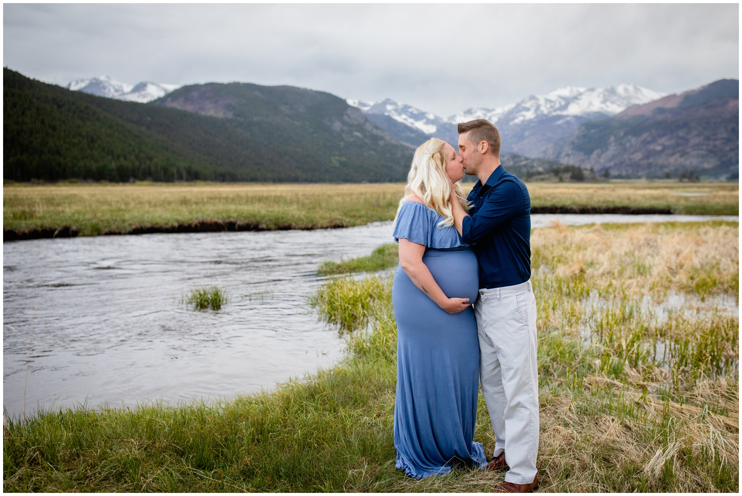 couple kissing next to the river during Estes Park pregnancy photos in RMNP