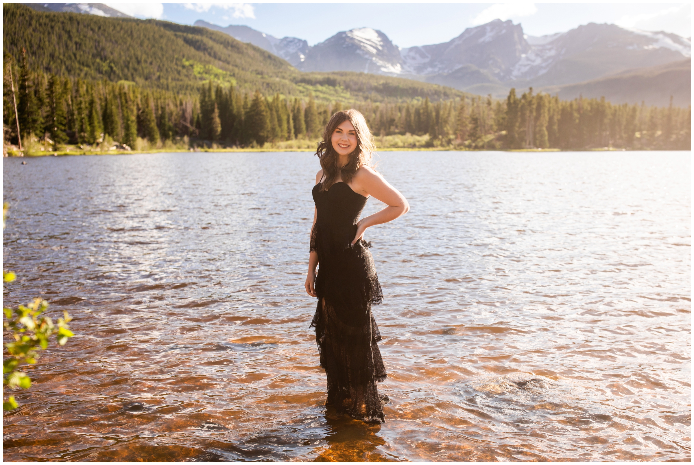 teen standing in a lake during Estes Park senior portraits in Rocky Mountain National Park 