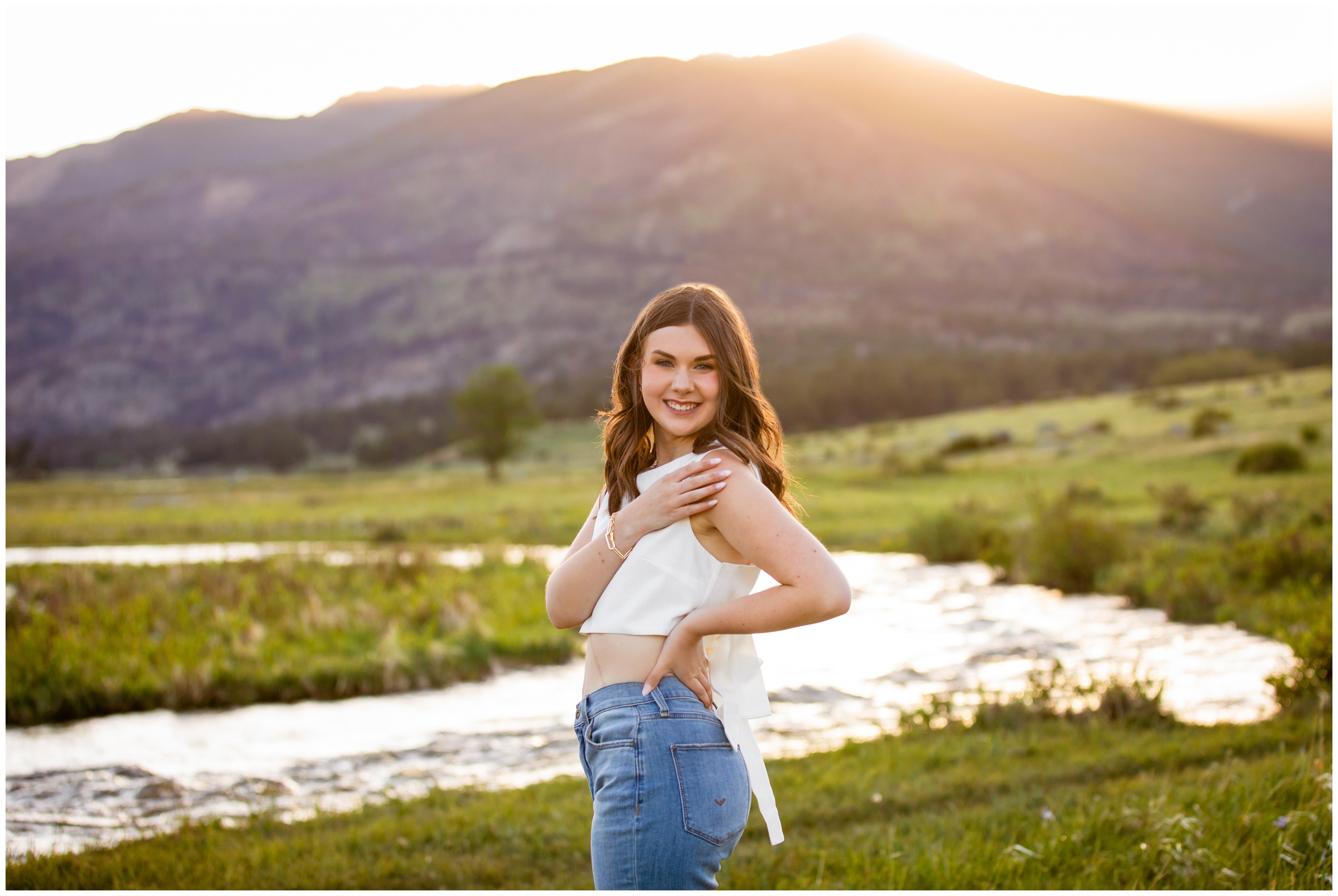teen posing next to the river at sunset during Estes Park senior pictures in Rocky Mountain National Park 