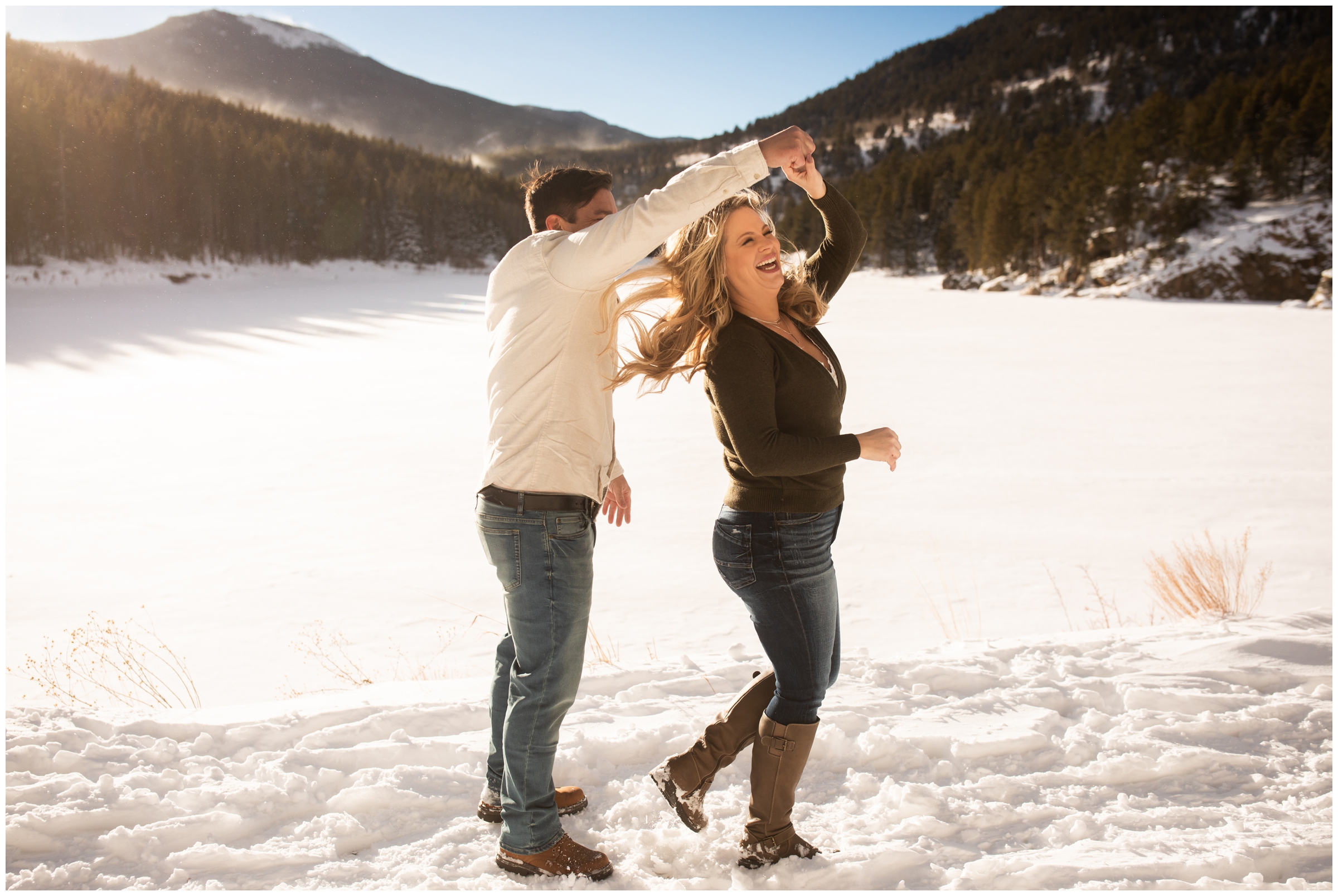 couple dancing in the snow during winter engagement portraits in Evergreen Colorado 
