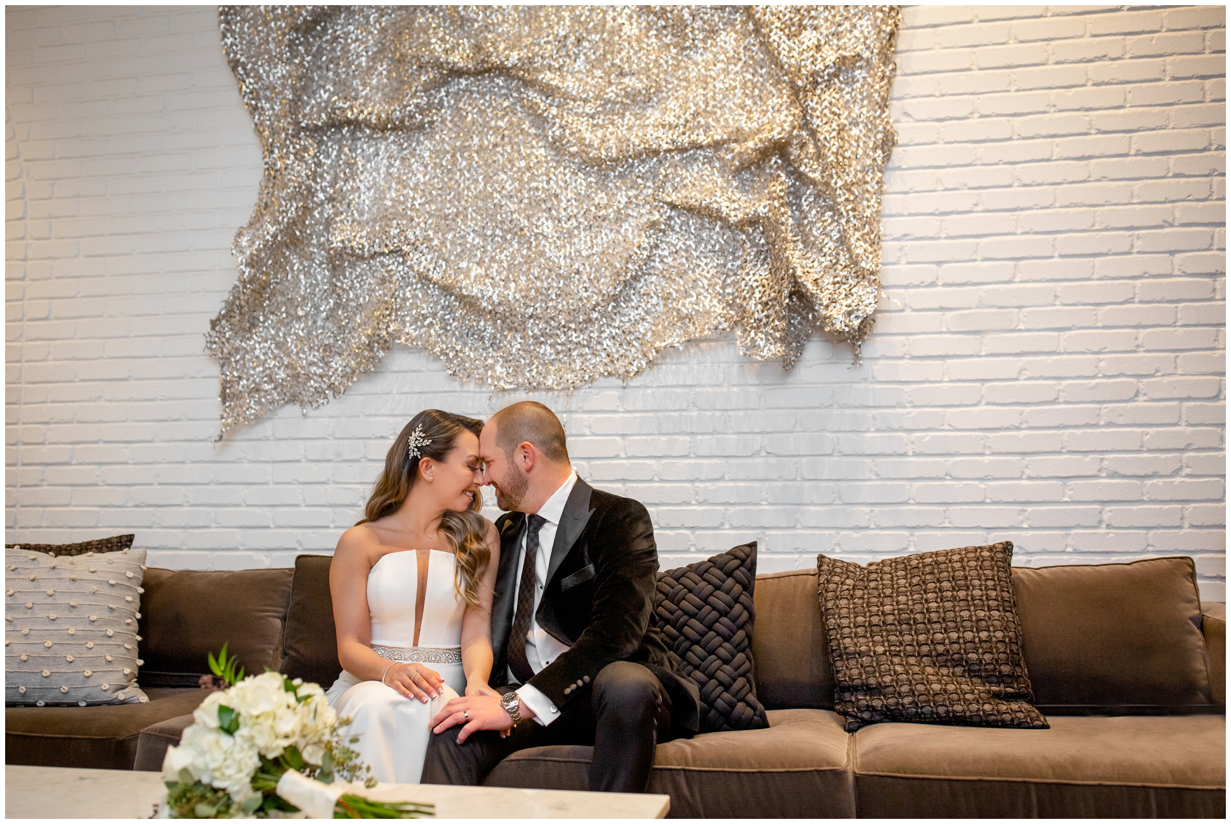 couple cuddling on a couch during Halcyon Denver wedding photos in Cherry Creek by Colorado photographer Plum Pretty Photography