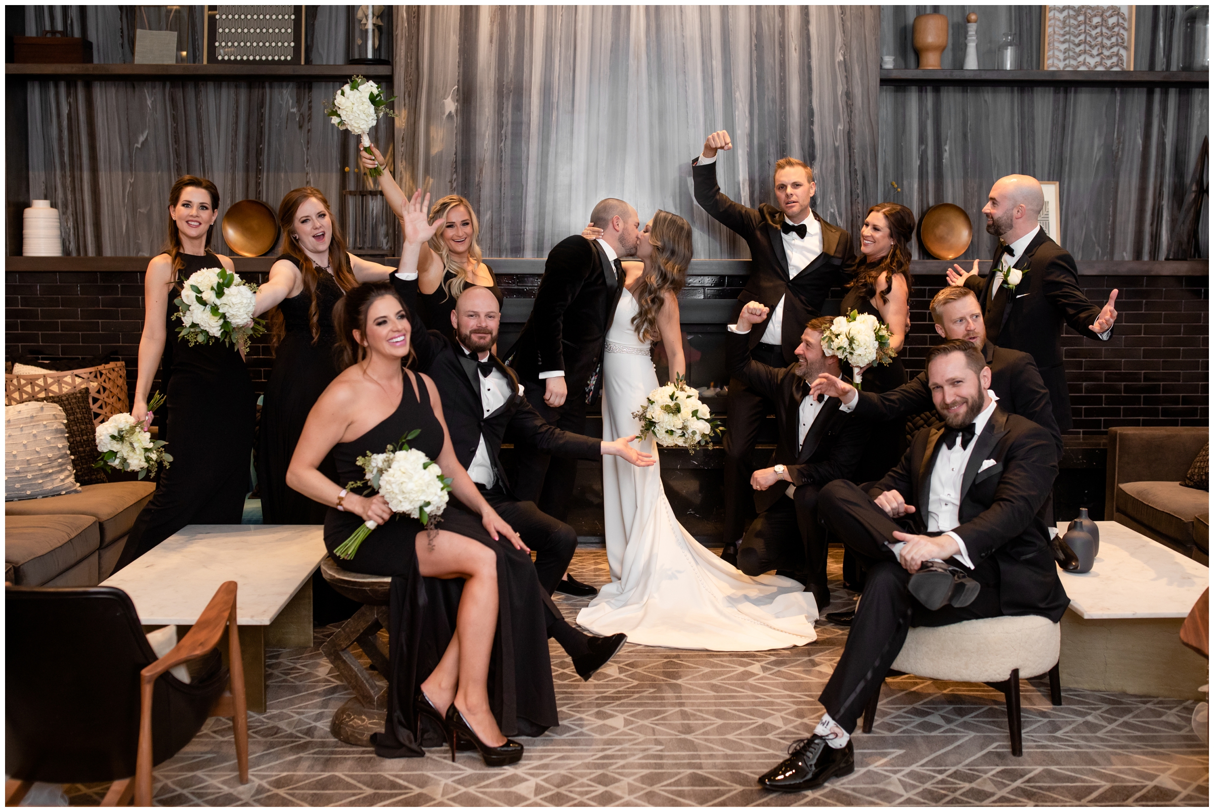 couple kissing in front of modern fireplace during Halcyon Hotel Cherry Creek wedding pictures 