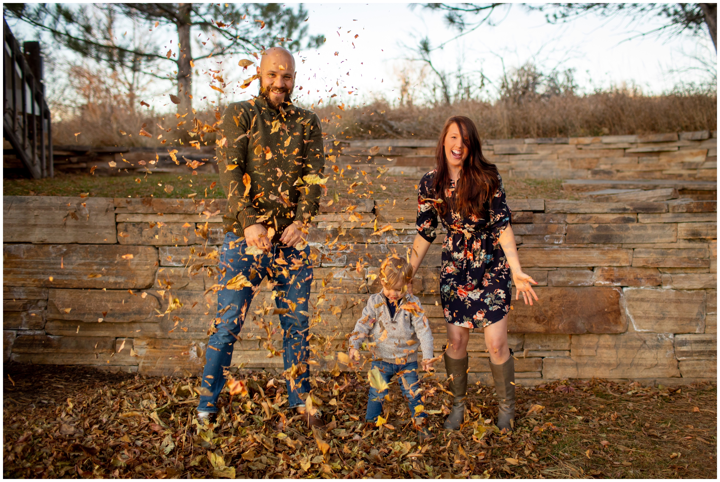 family throwing leaves during candid Colorado family photography session at Sandstone Ranch in Longmont 