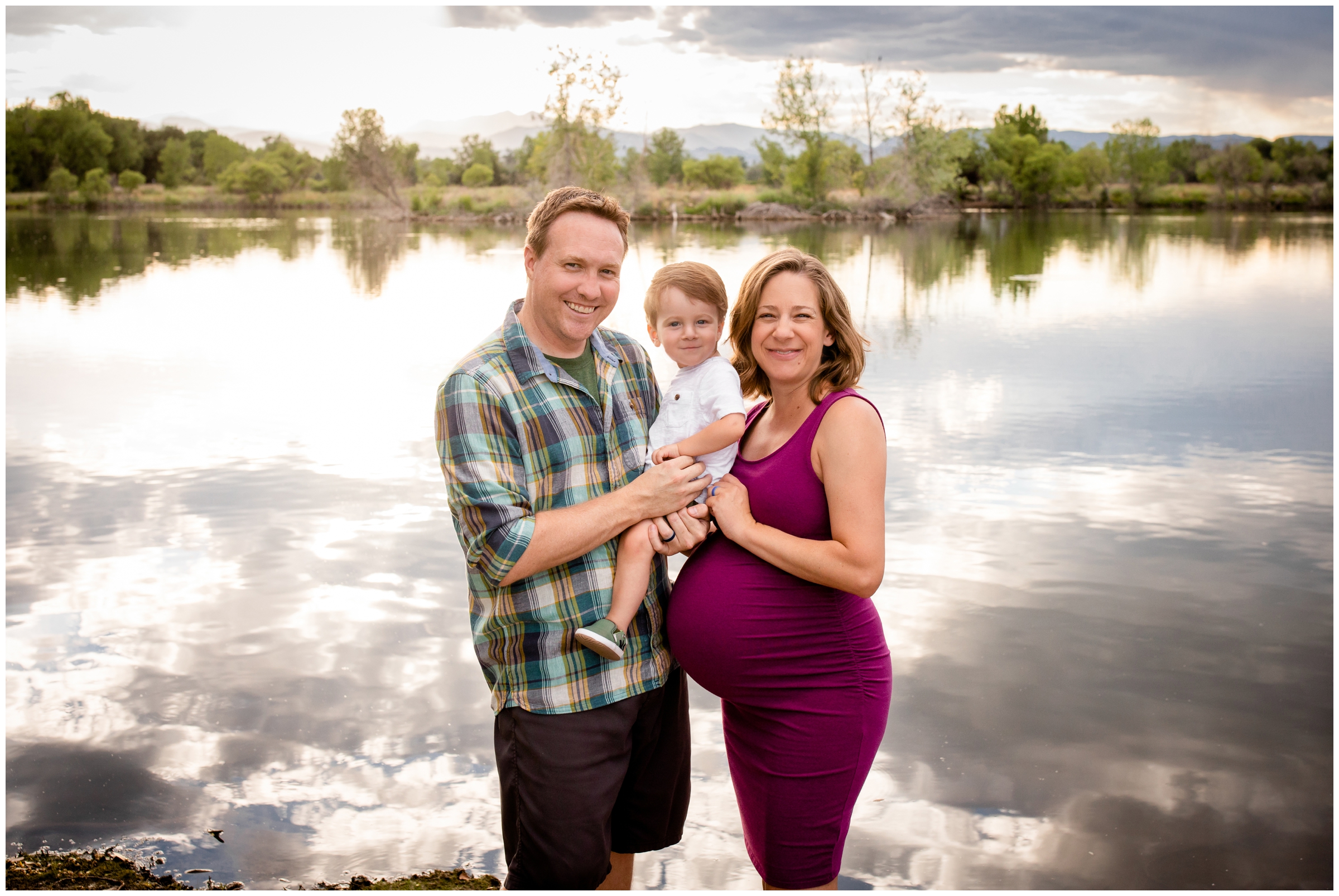 family posing next to a Colorado lake during Longmont maternity family portraits 