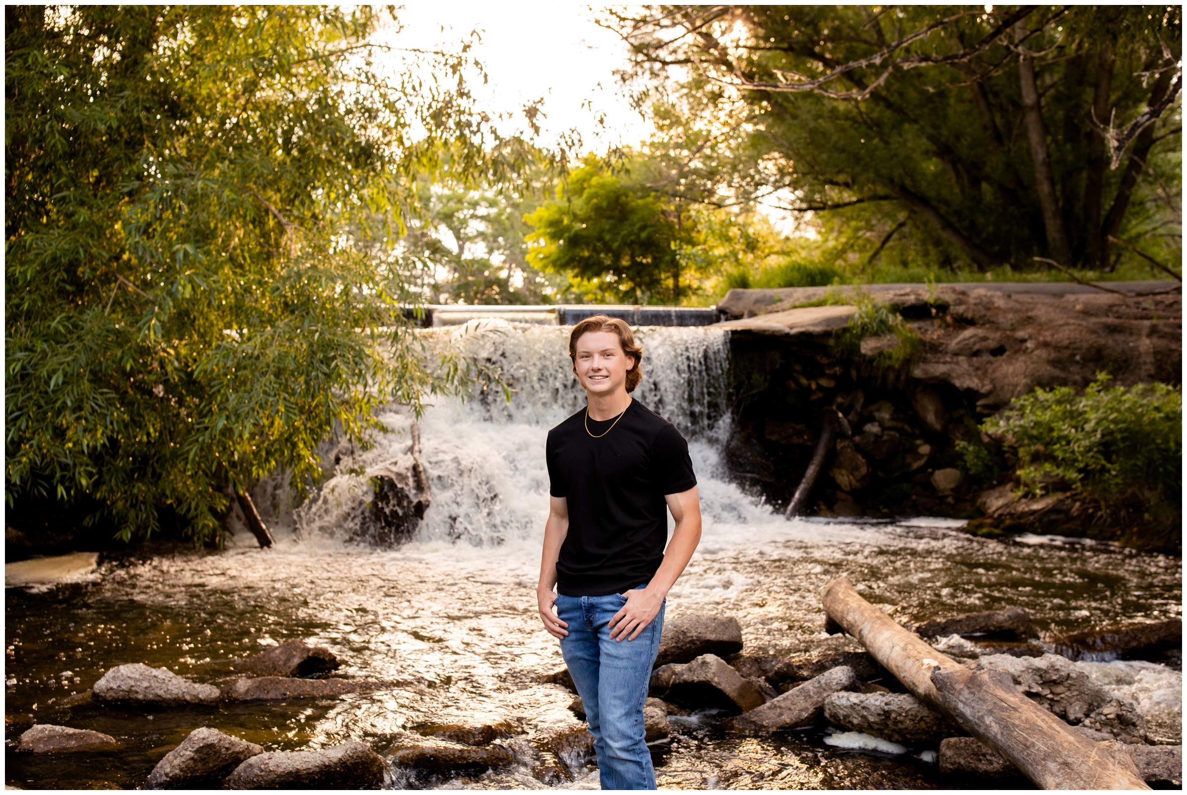 teen guy posing by waterfall at Golden Ponds during Longmont Colorado senior pictures 