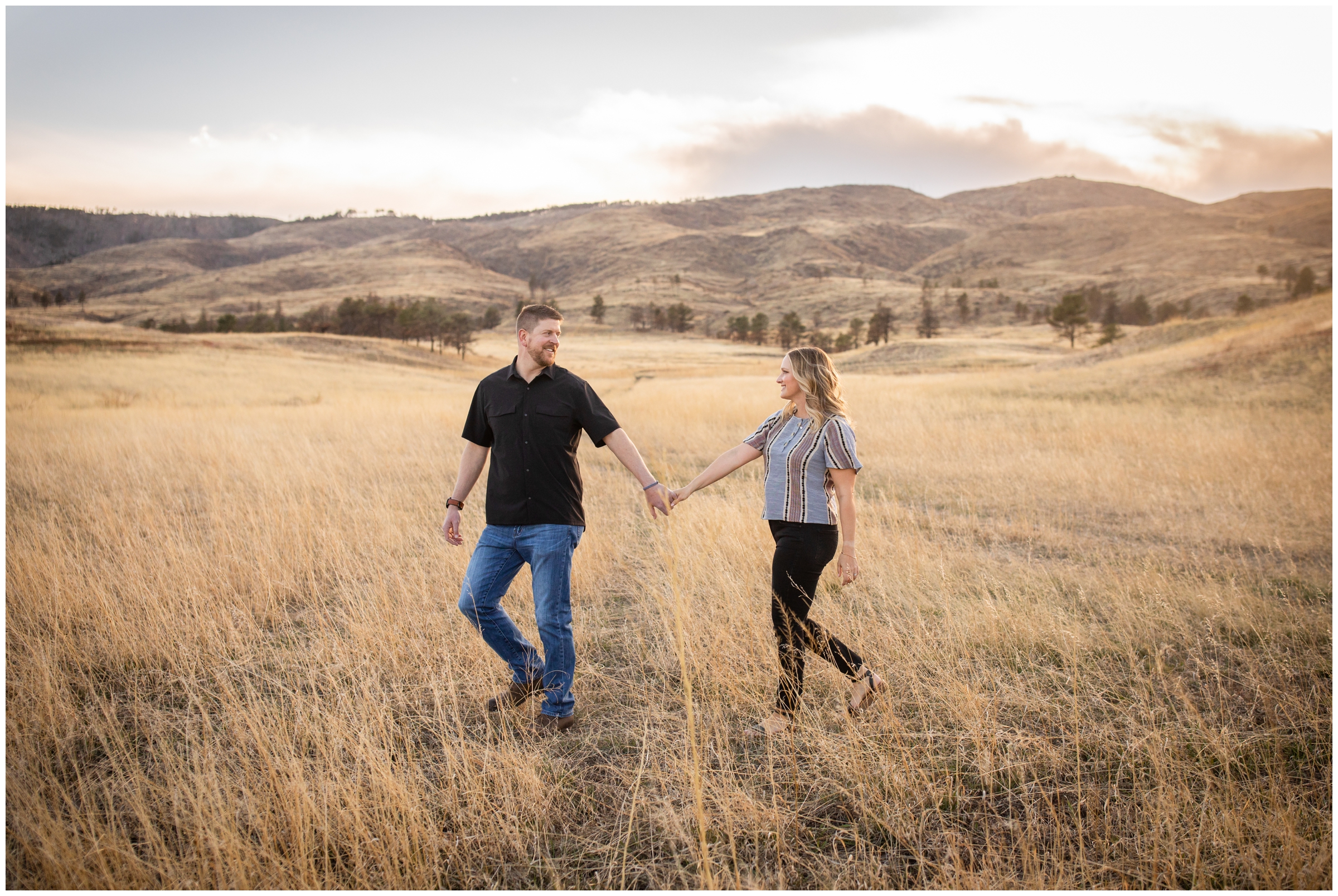 couple walking in a field during Northern Colorado mountain anniversary pictures at bobcat ridge 