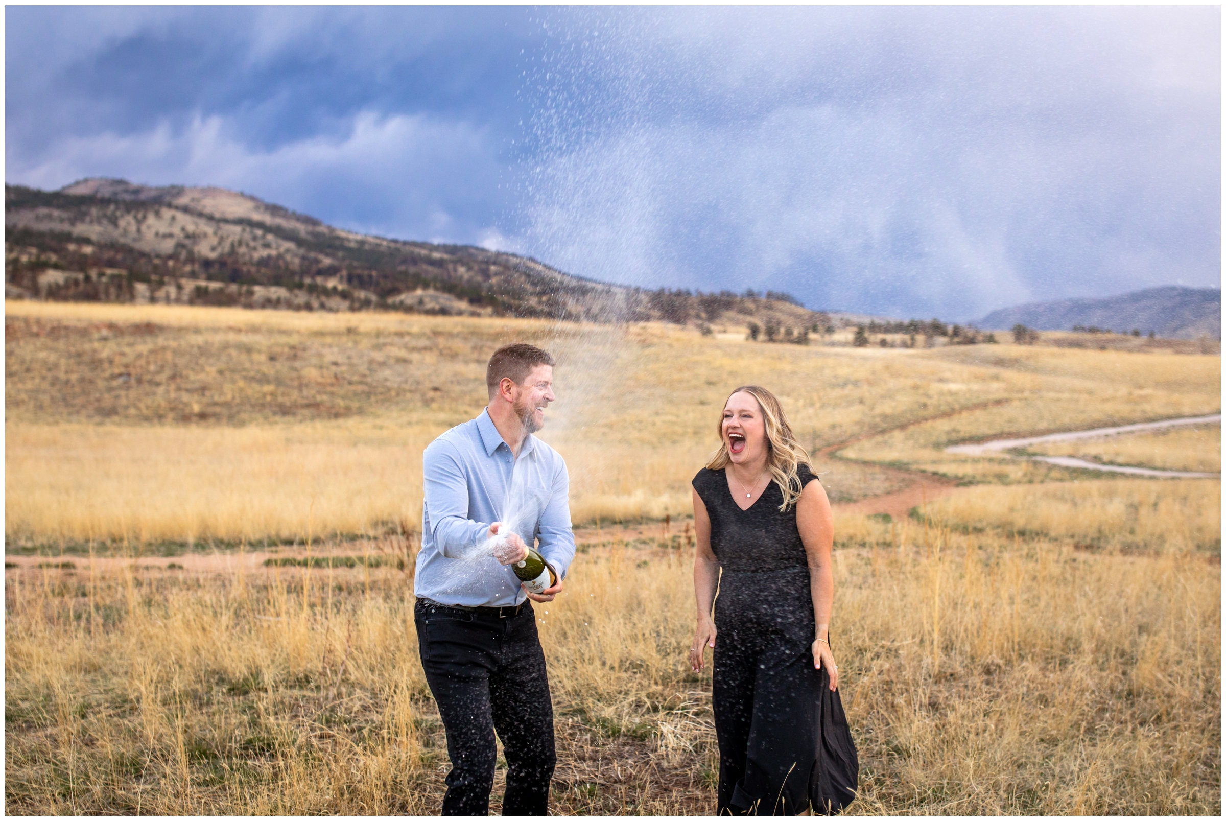 couple spraying champagne during Colorado 40th birthday photo session in Fort Collins 