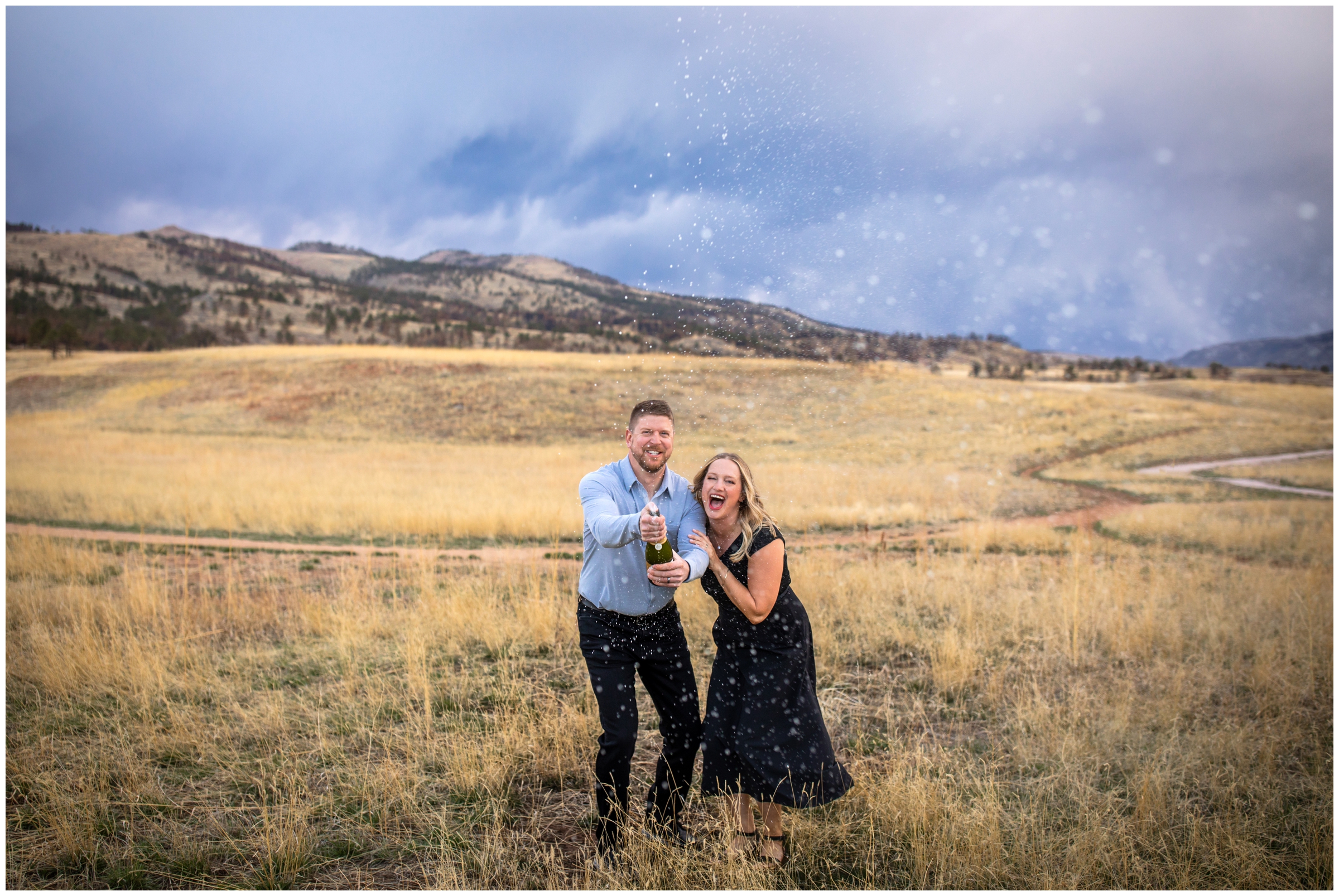 couple spraying champagne during Loveland Colorado couples portraits by Plum Pretty Photography