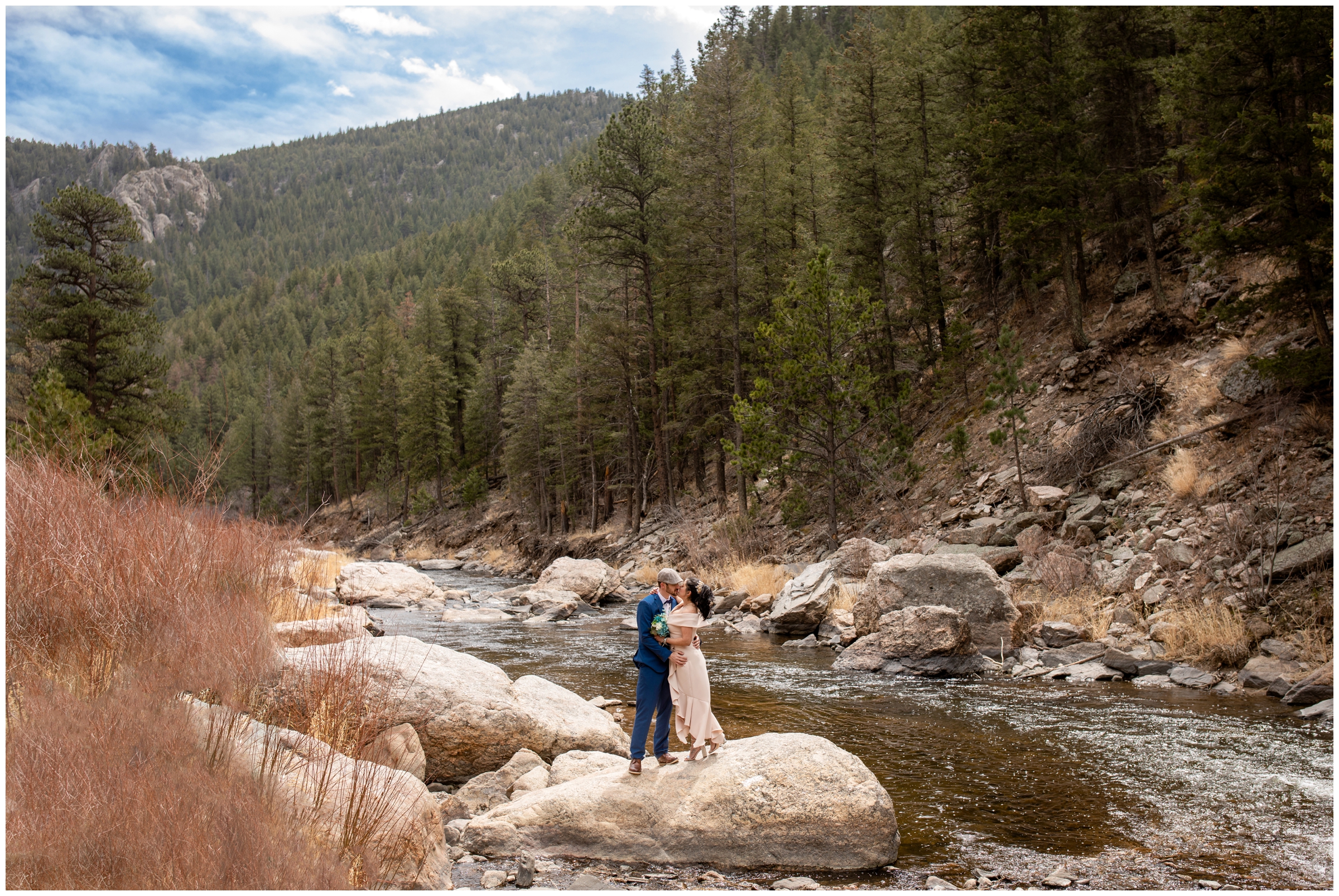 wedding couple posing on a rock next to the Big Thompson River during spring elopement wedding pictures in Loveland Colorado 
