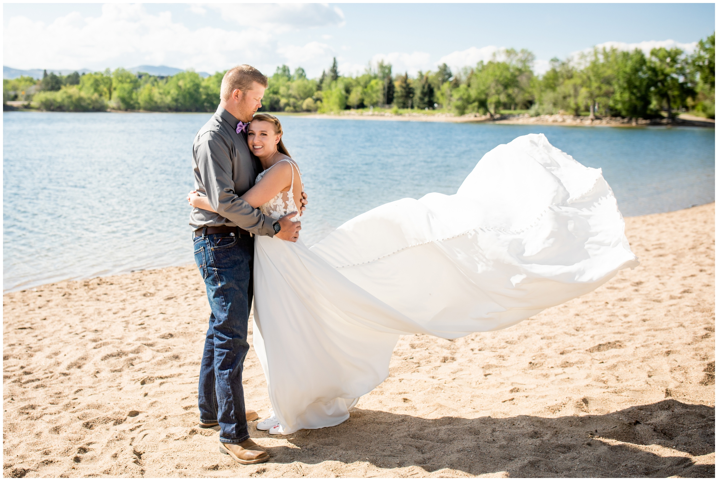 bride's train flying in the wind during Lake Loveland Colorado wedding photos 