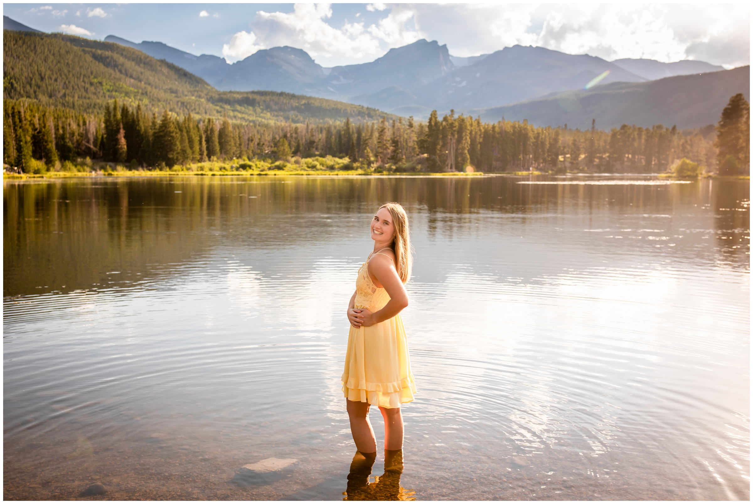 teen standing in lake during Colorado mountain senior pictures at Sprague Lake