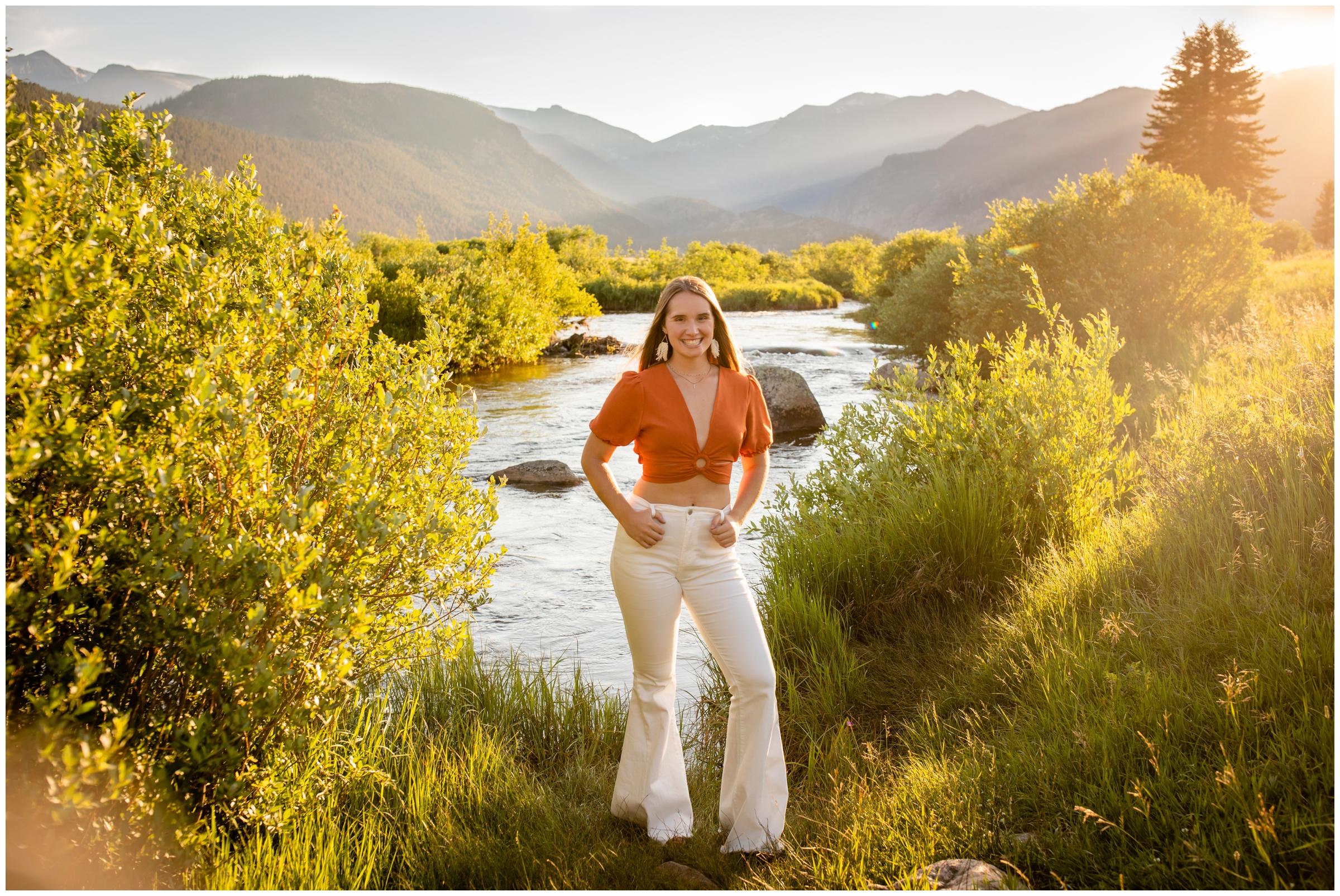teen girl posing next to the river with mountains in background during Estes Park Colorado senior pictures 