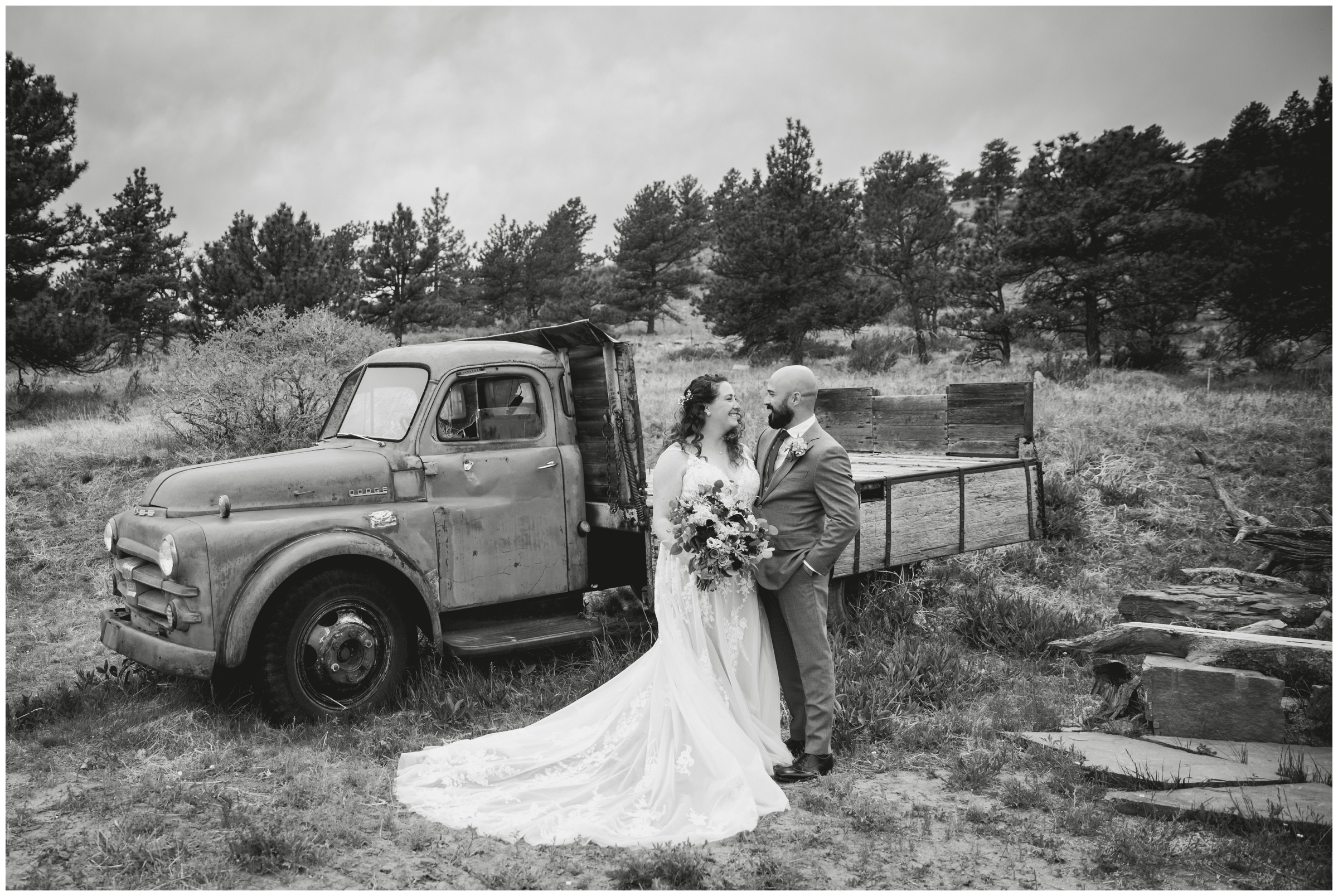 couple posing in front of old vintage truck during Lyons Colorado wedding at Lionscrest Manor