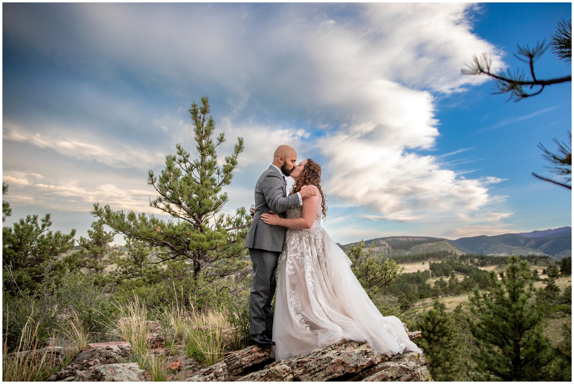 couple kissing beneath dramatic sunset sky at Lioncrest Manor wedding in Lyons Colorado