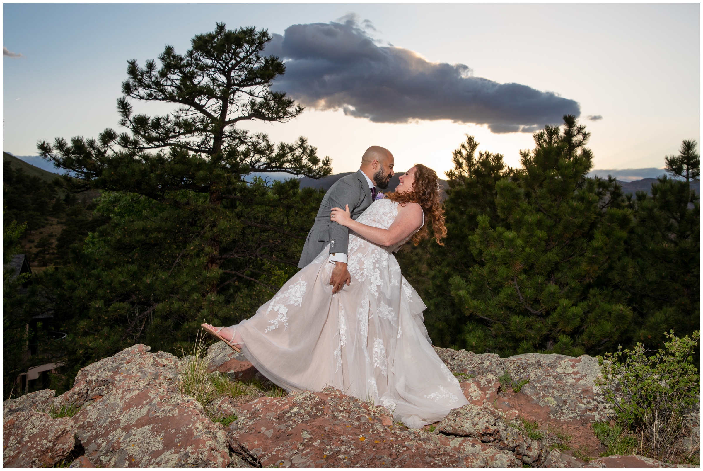 groom dipping bride on rock formations during Colorado mountain wedding in Lyons