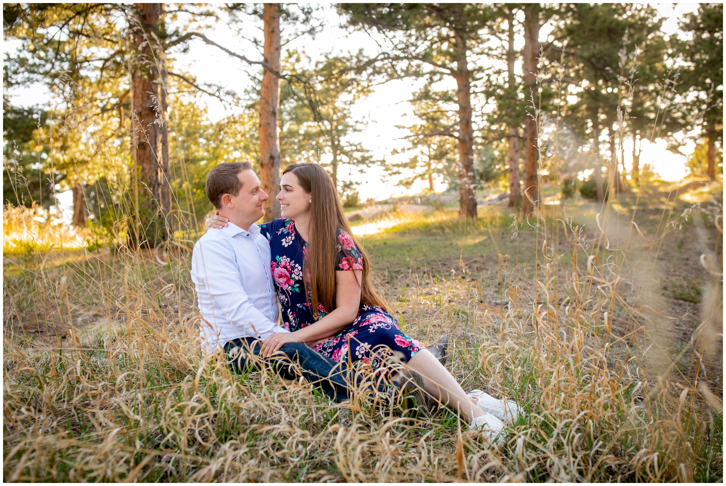 couple sitting in the grass during Colorado engagement portraits at Mount Falcon by Plum Pretty Photos
