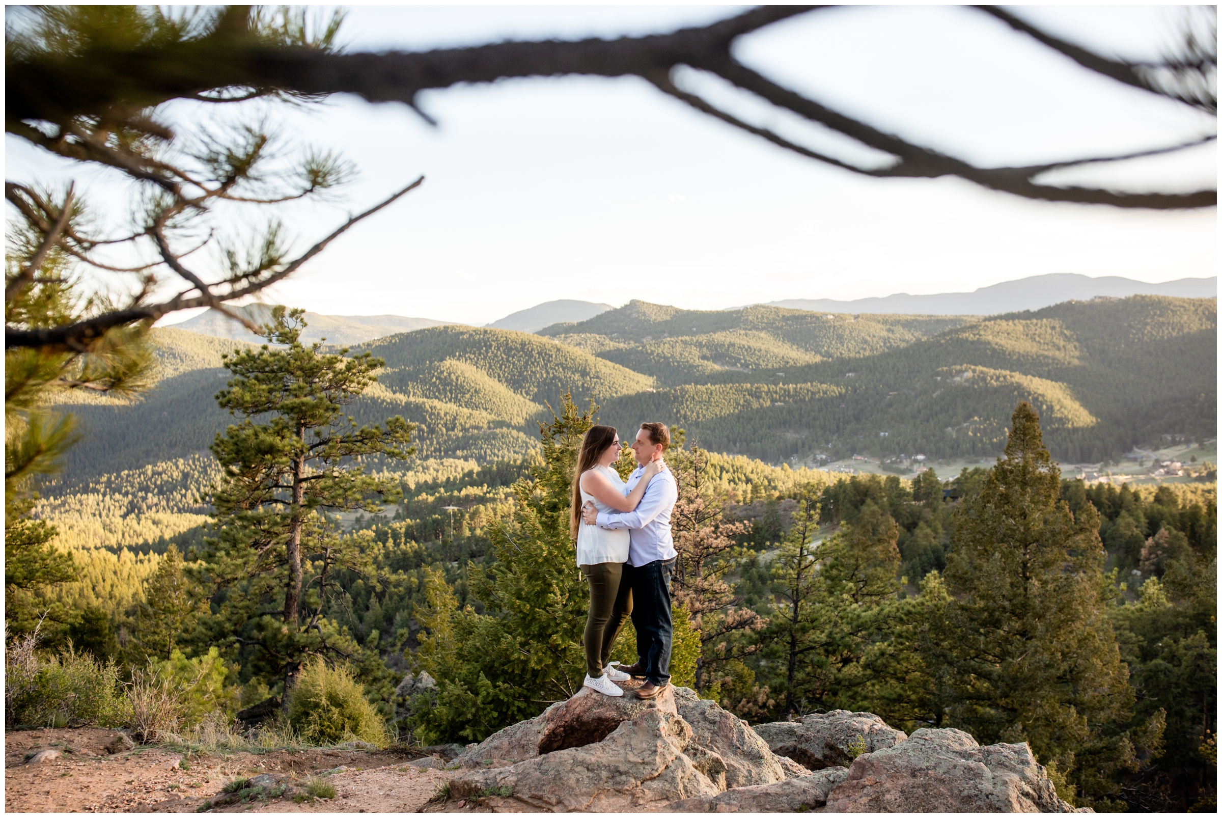 couple standing on rock formations during Colorado mountain engagement portraits at Mount Falcon by Plum Pretty Photography 