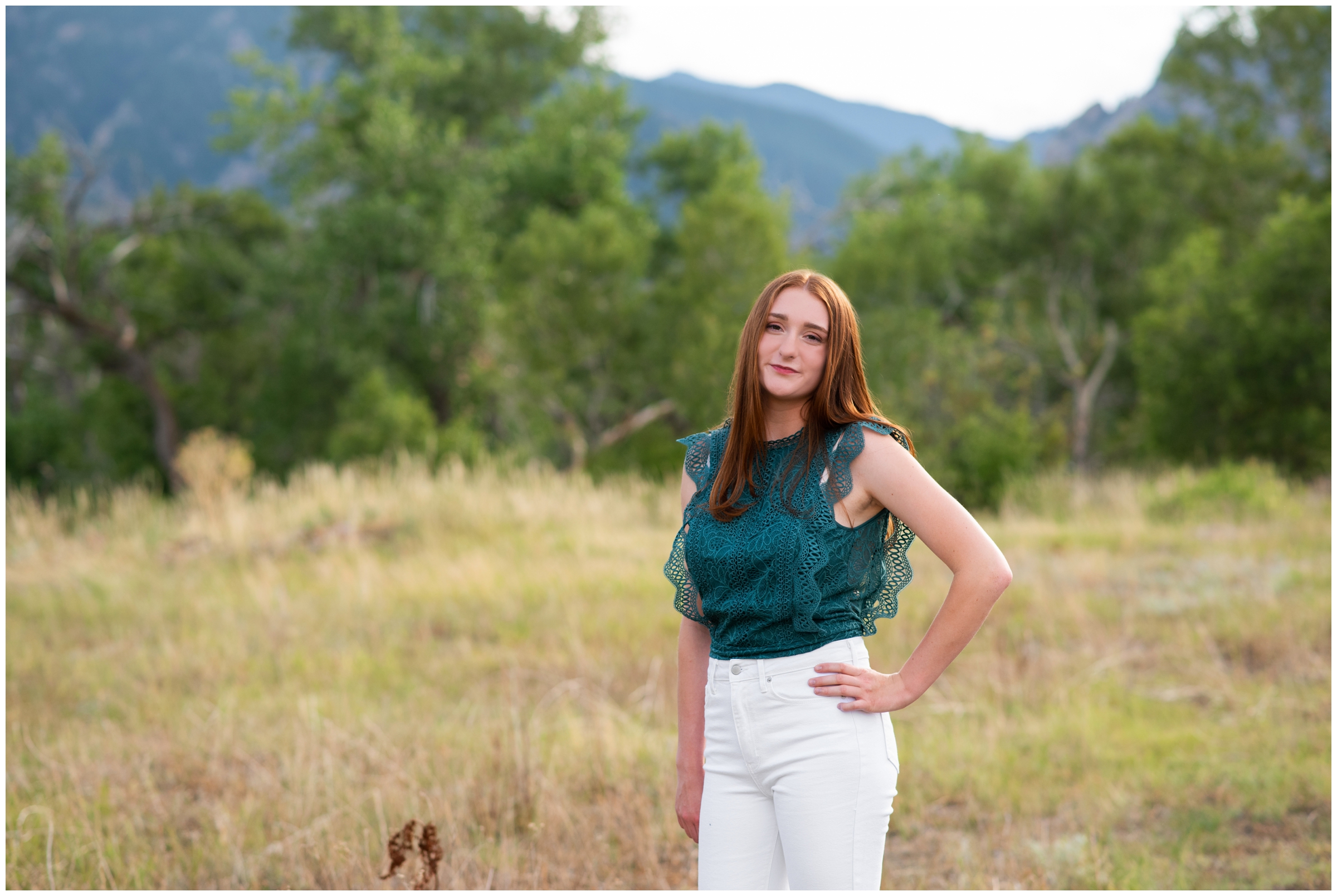 teen posing with mountains in background during Colorado summer senior portraits at South Mesa Trail in Boulder 
