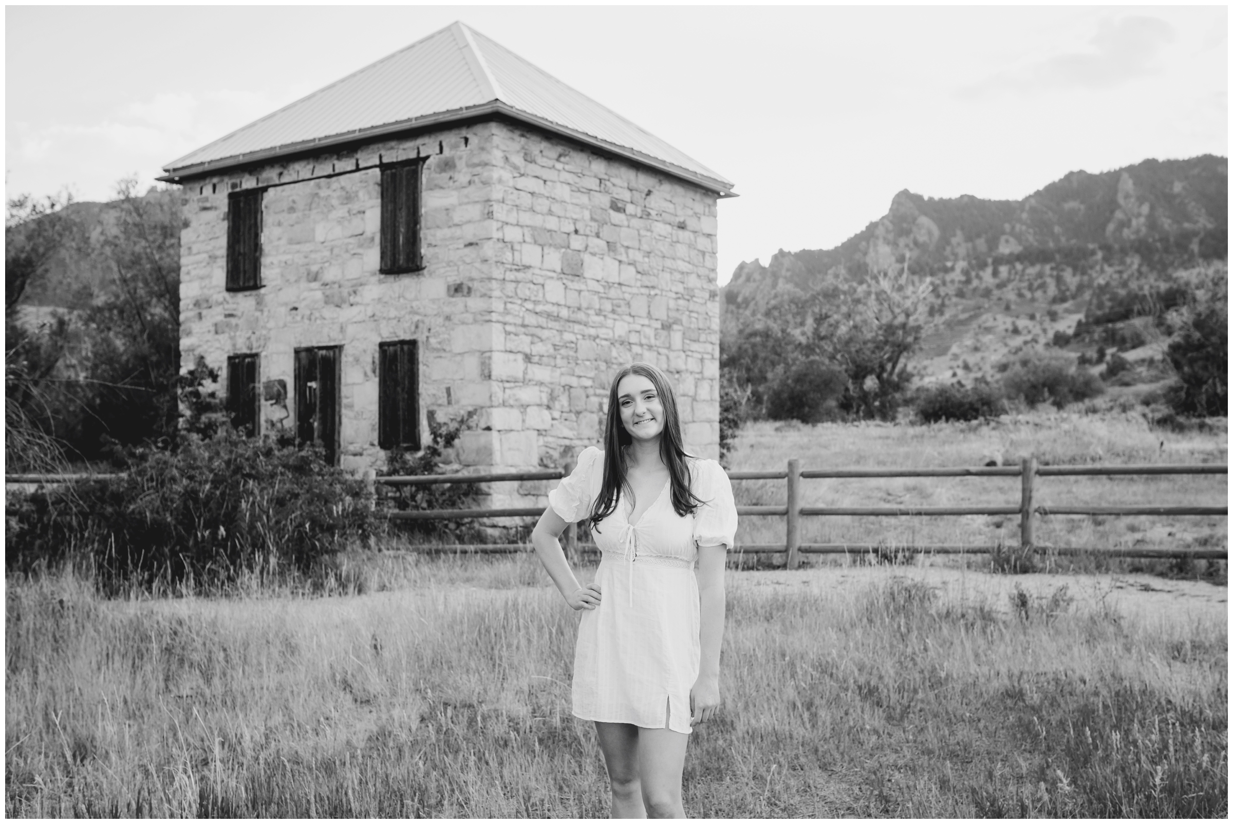 teen posing with flatirons mountains in background during Boulder senior photography session at South Mesa 