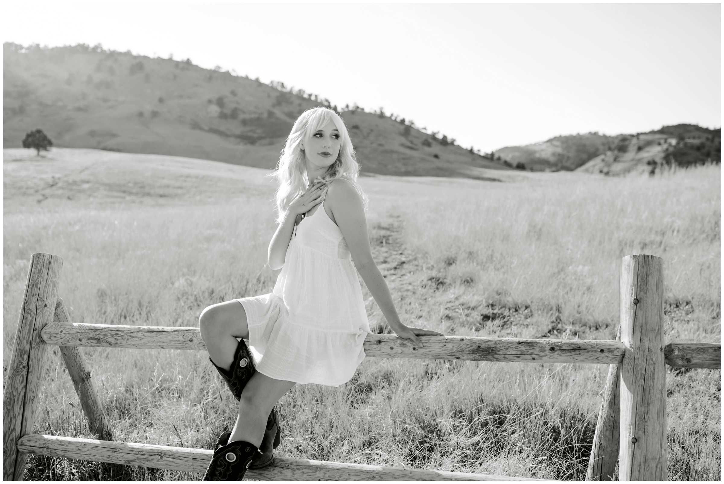 teen girl posing on wooden fence during Colorado mountain graduation pictures 