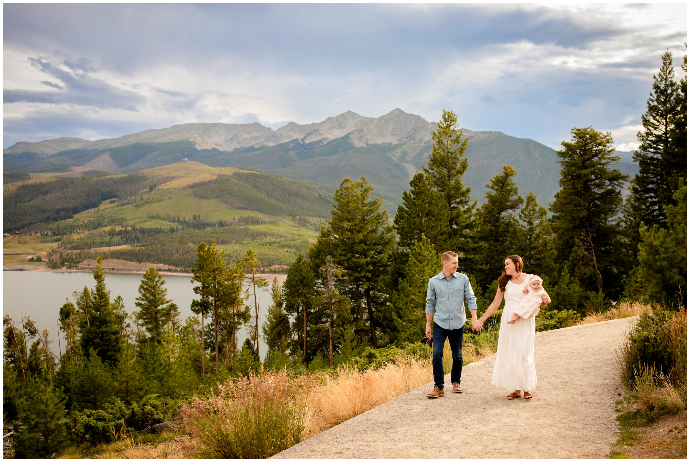 family of three walking on trail during candid family pictures at Sapphire Point during Breckenridge family portraits 