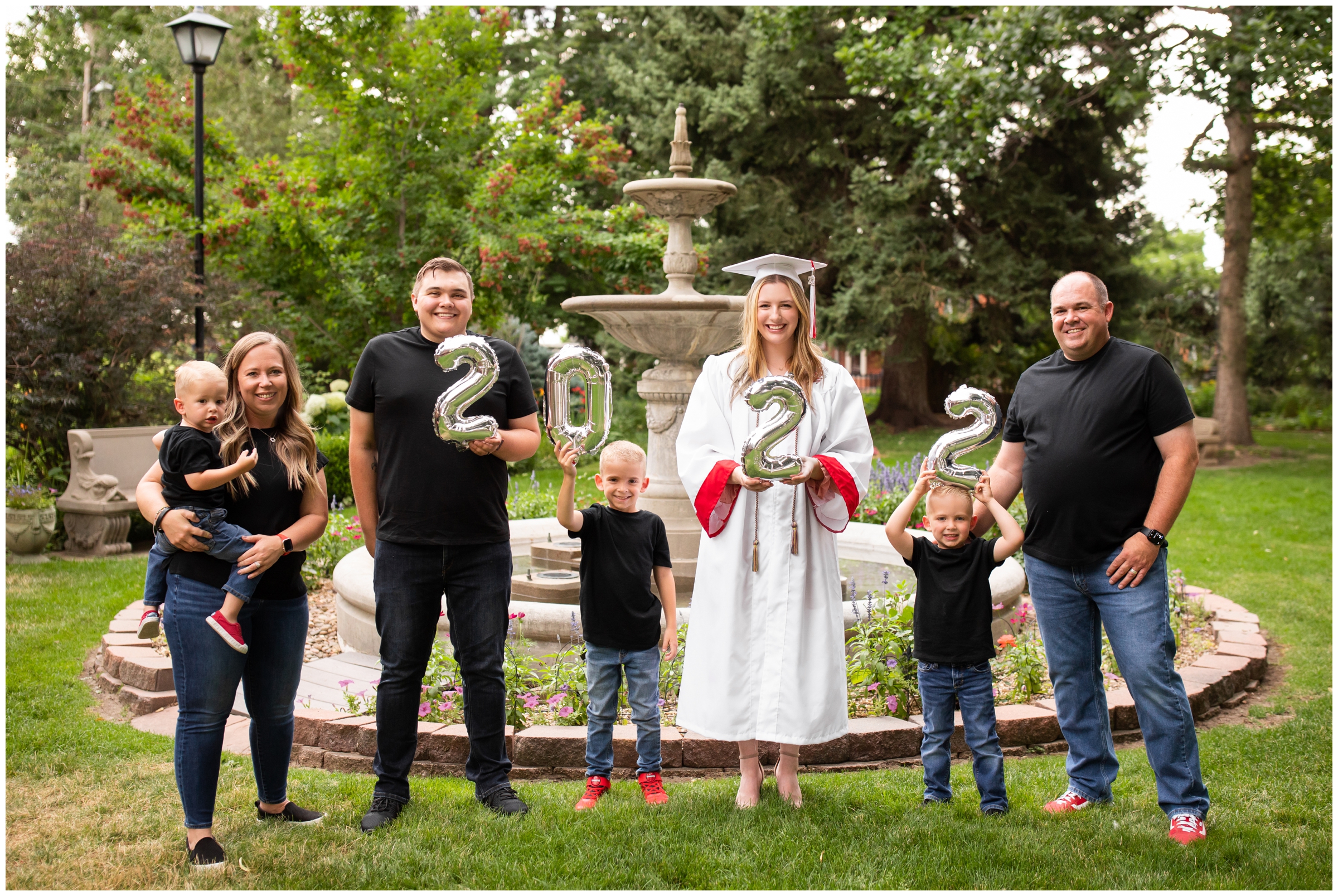 family holding number balloons for Colorado graduation portraits in Longmont 