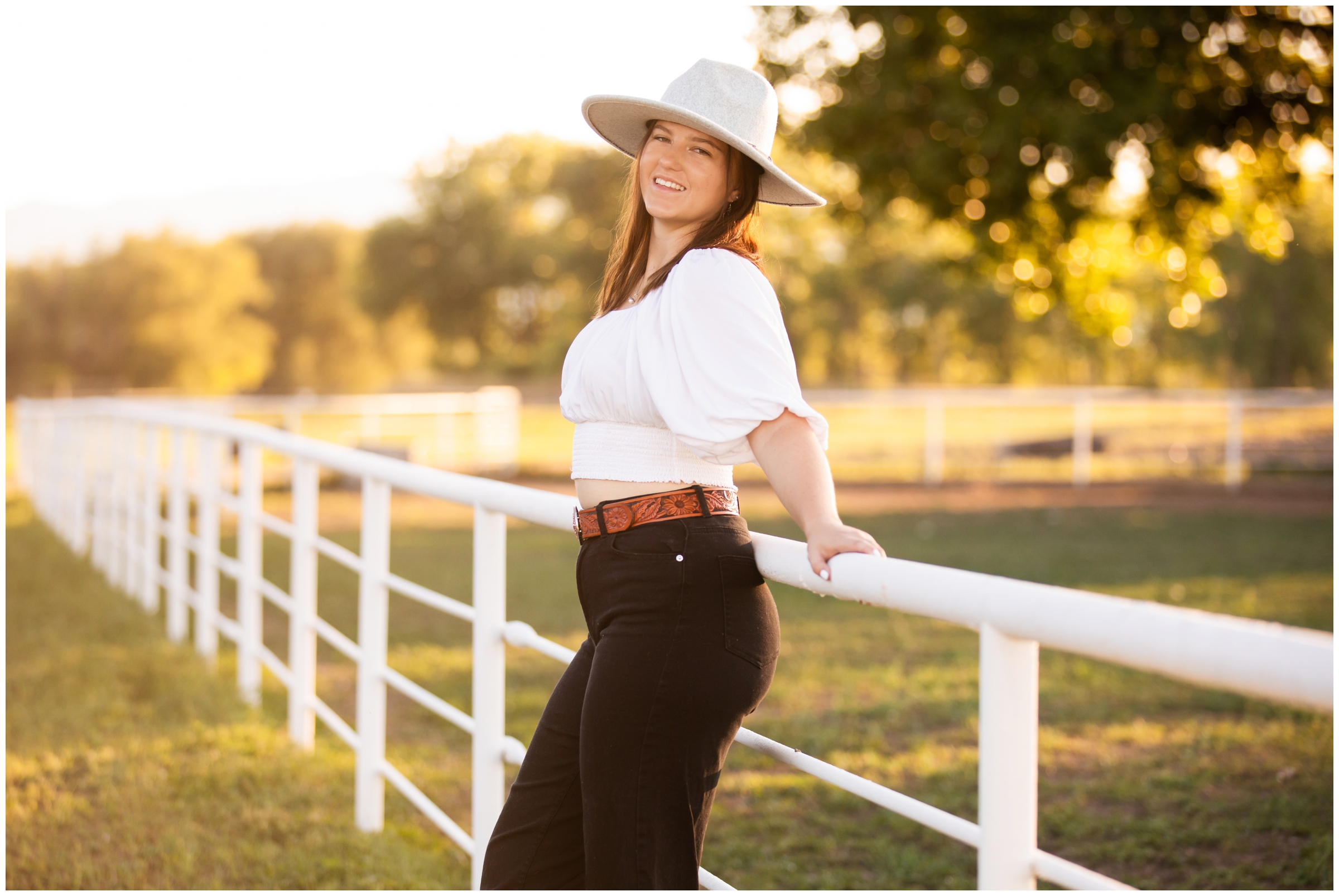 teen leaning against a fence at horse farm during Longmont senior photos 