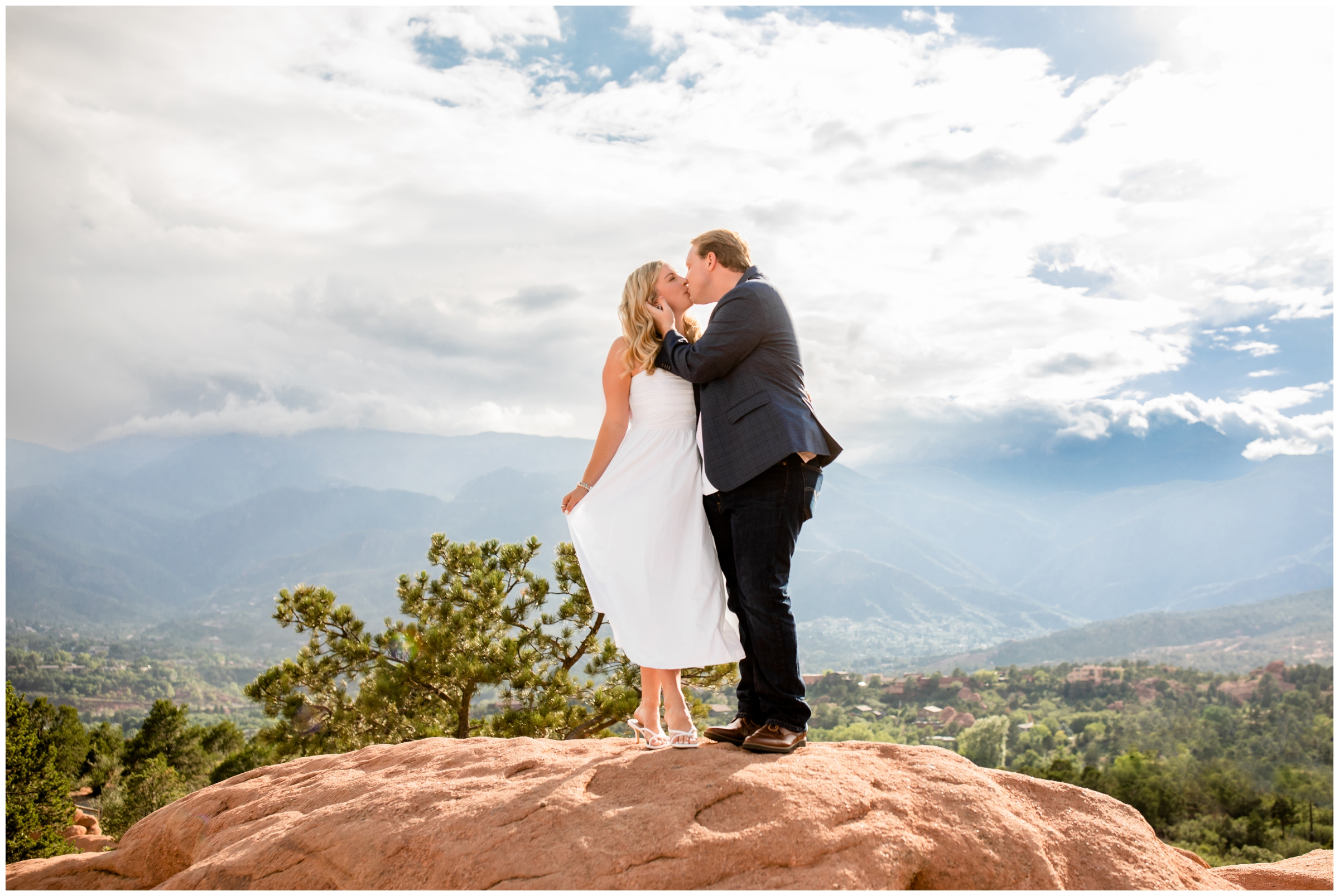couple kissing on rock formation during Colorado Springs engagement photos at Garden of the Gods