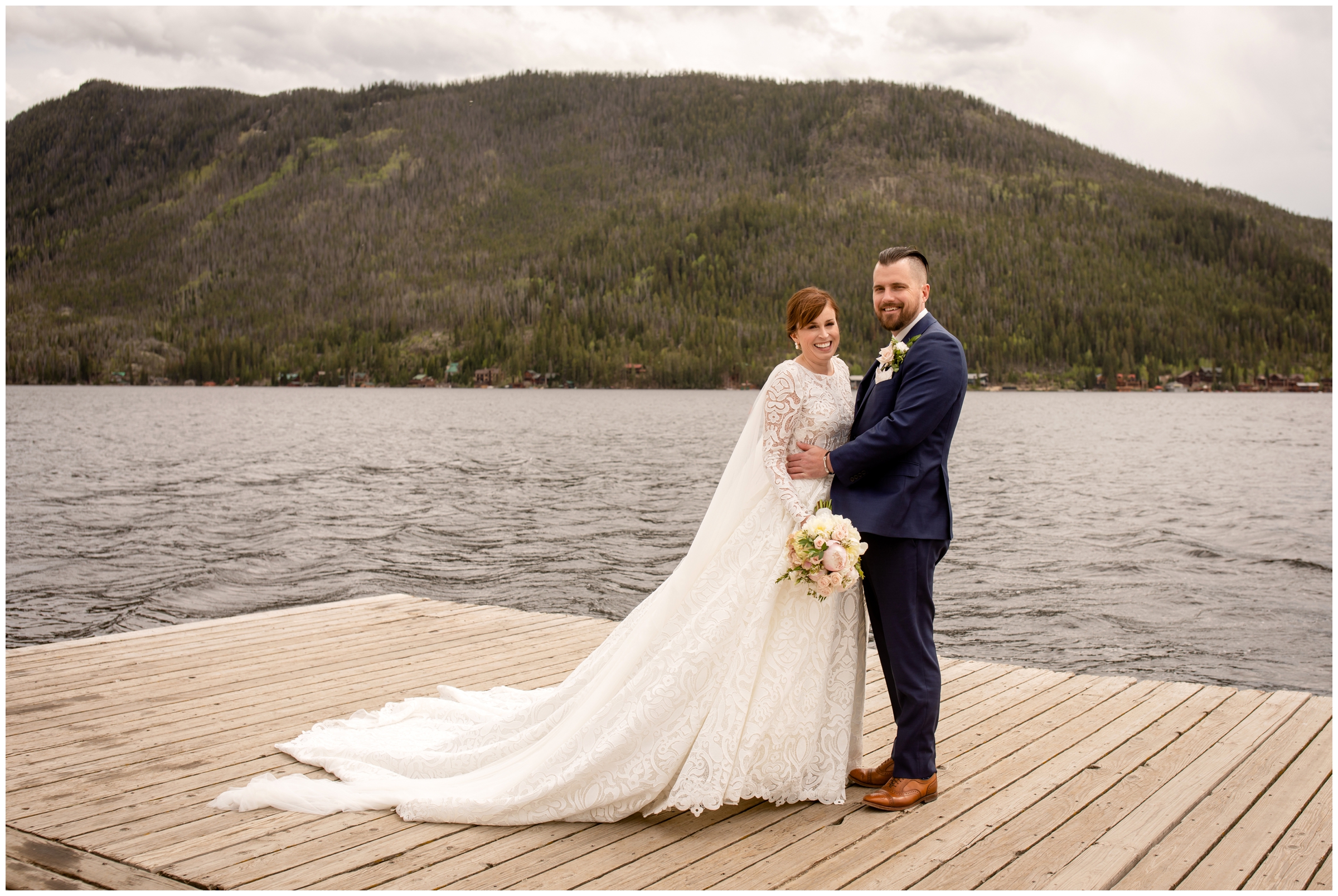 bride and groom posing o wooden docks in front of Grand Lake in the Colorado mountains 