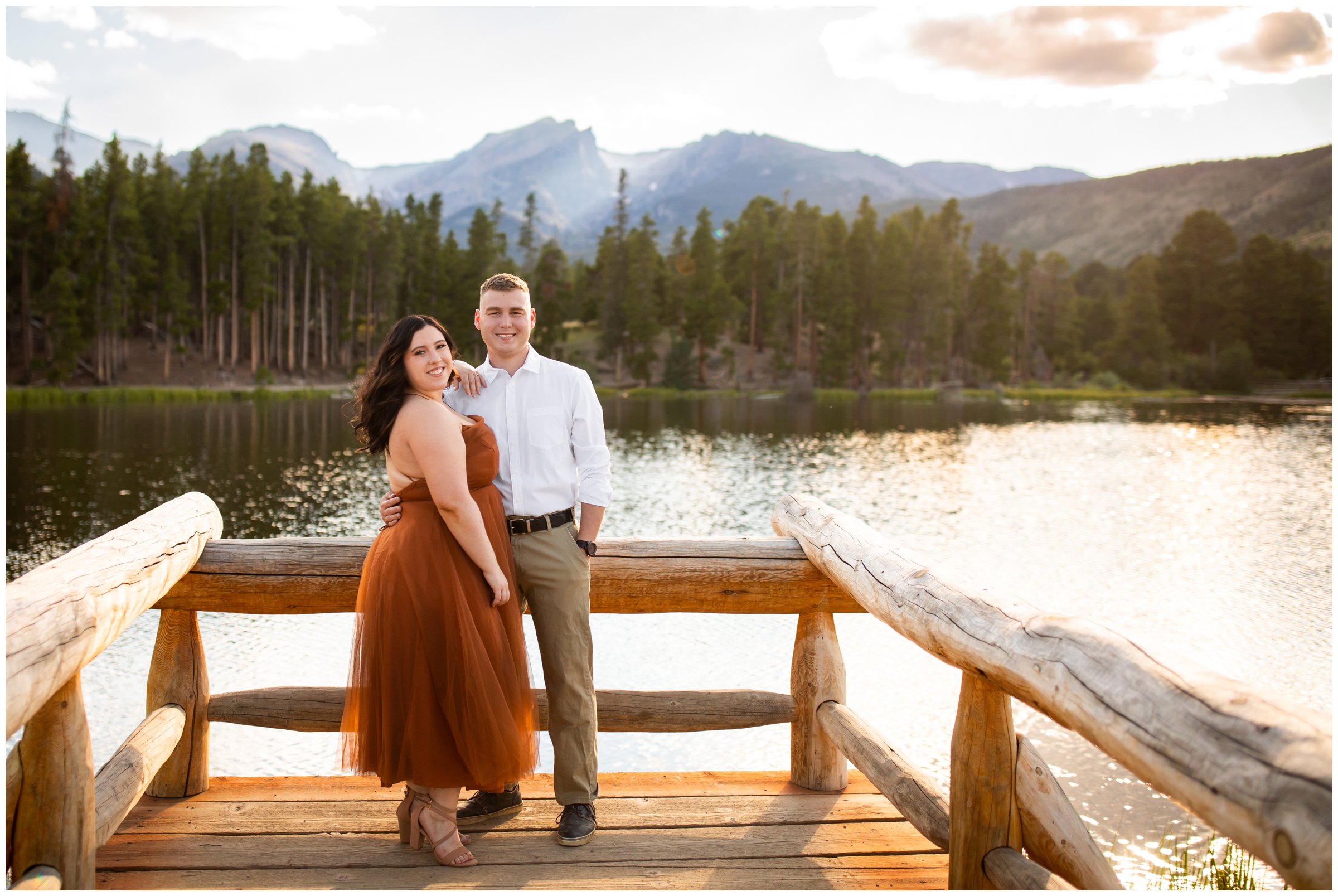 couple posing on dock at Sprague Lake during RMNP engagement photography session in Estes Park