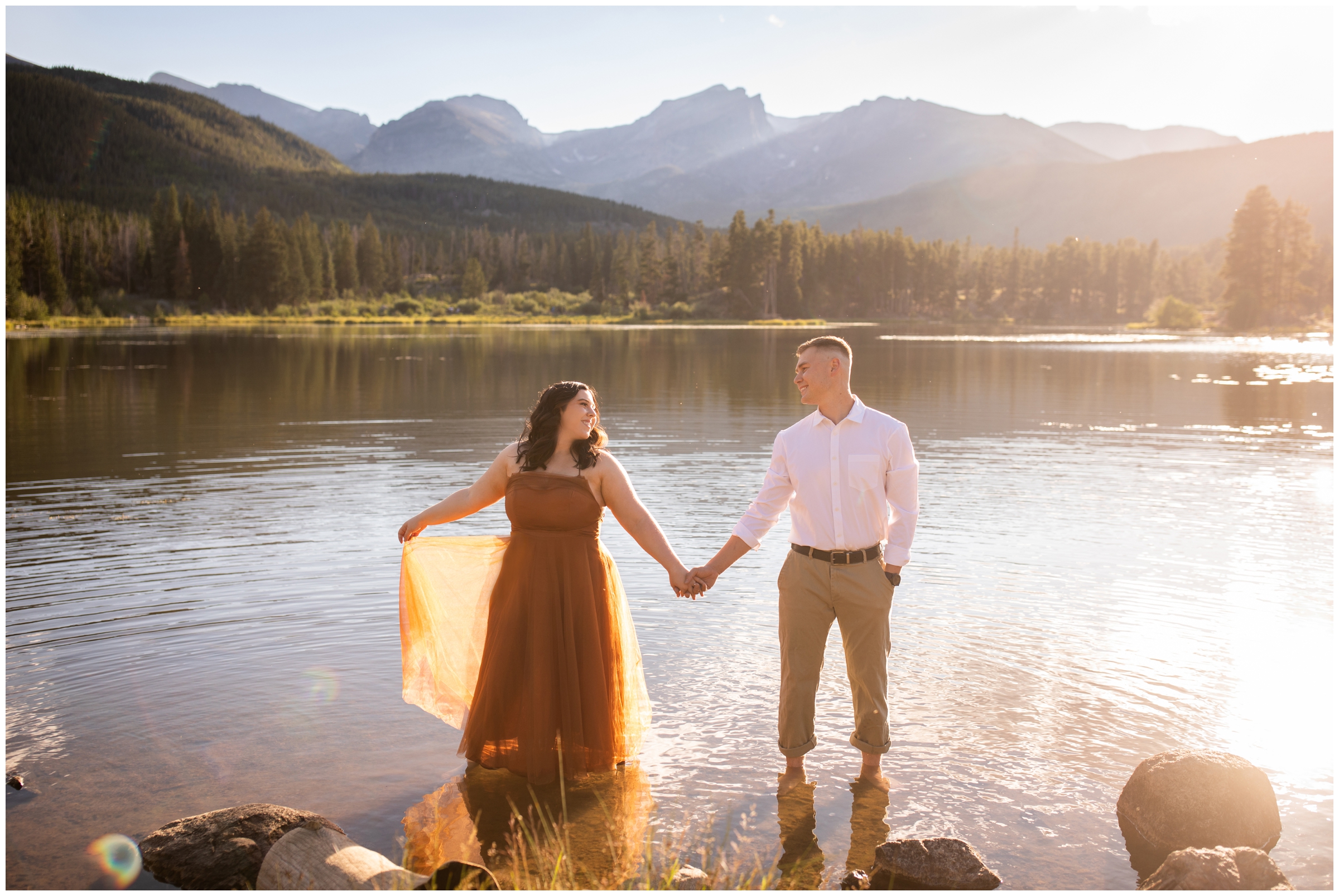 couple posing in a lake during RMNP Colorado engagement pictures by Plum Pretty Photography 