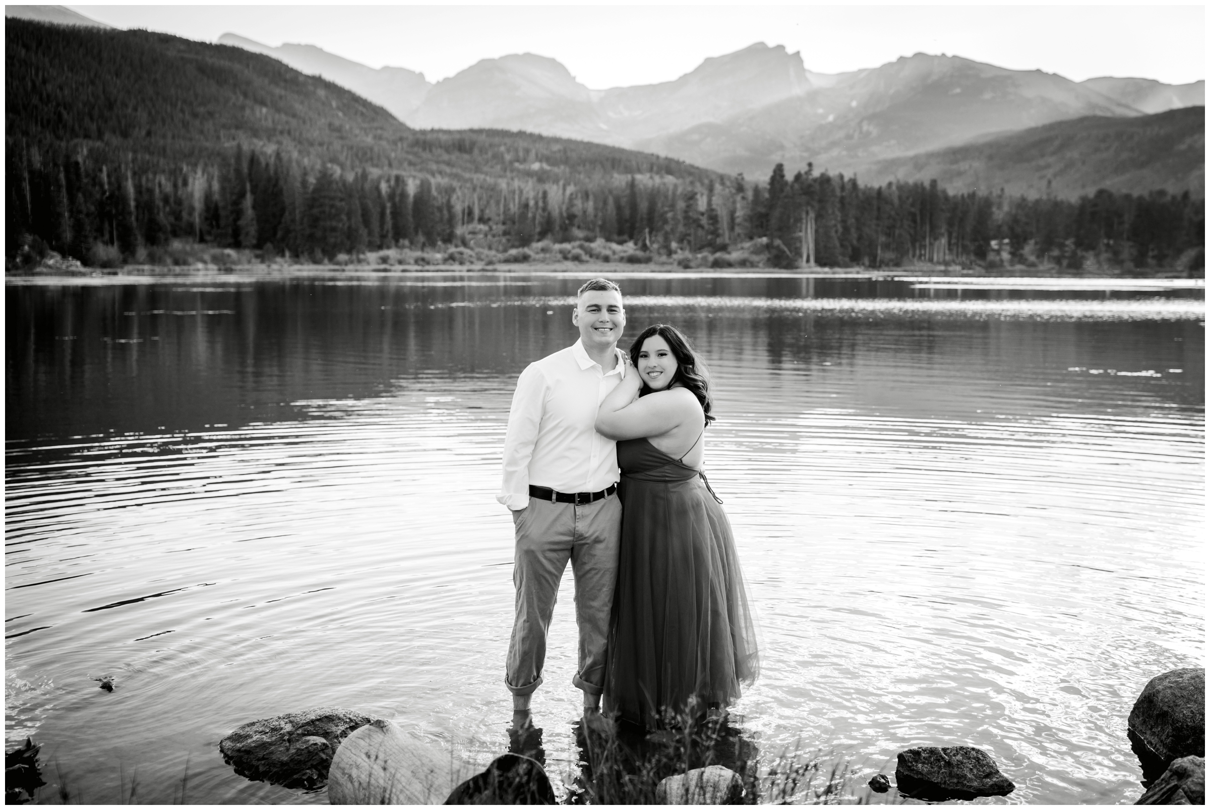 couple posing in a mountain lake during Estes Park Colorado summer engagement pictures 