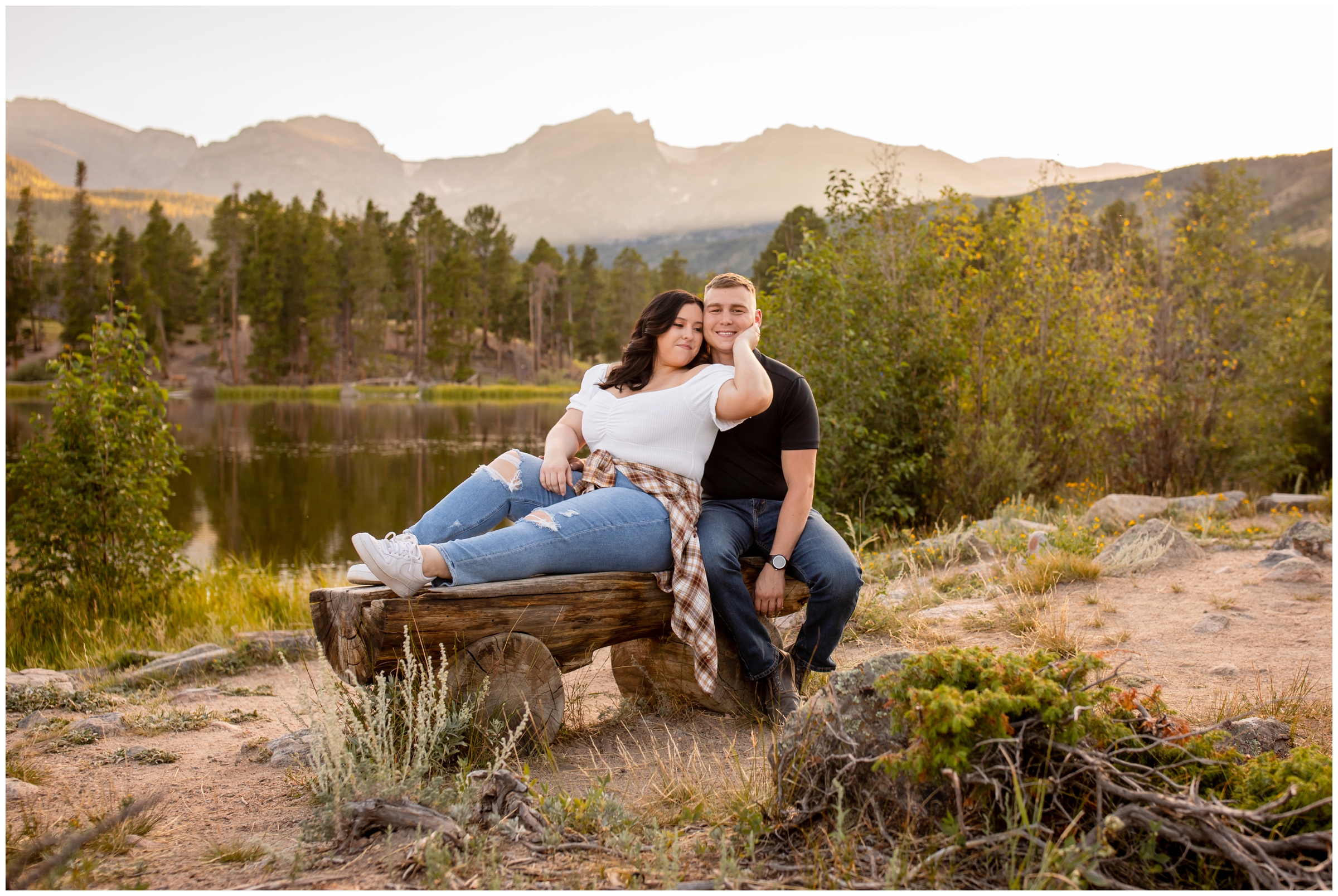 couple posing on a wooden bench at Sprague Lake during Rocky Mountain National Park photo shoot