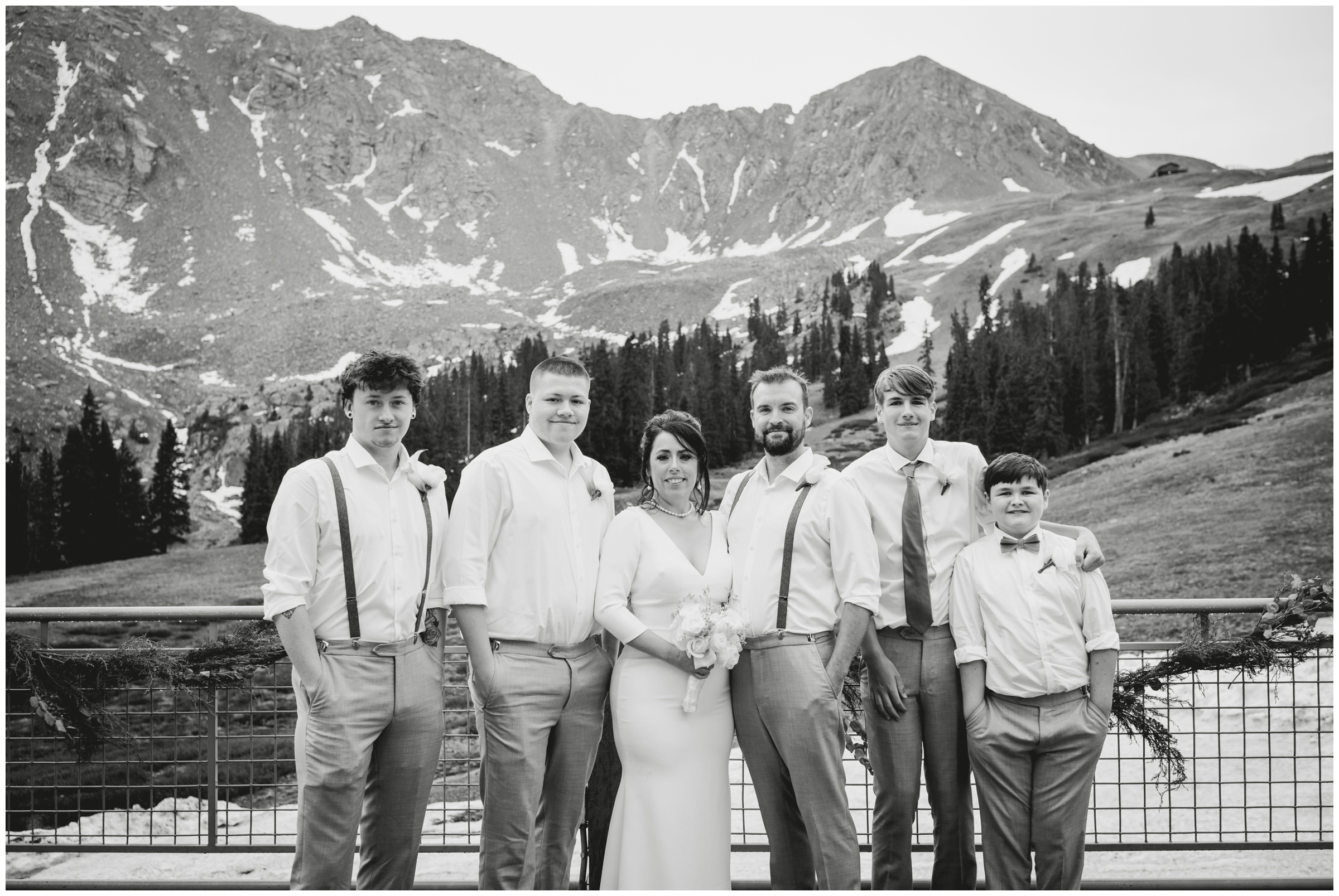 family posing in front of mountains during A Basin Colorado summer wedding