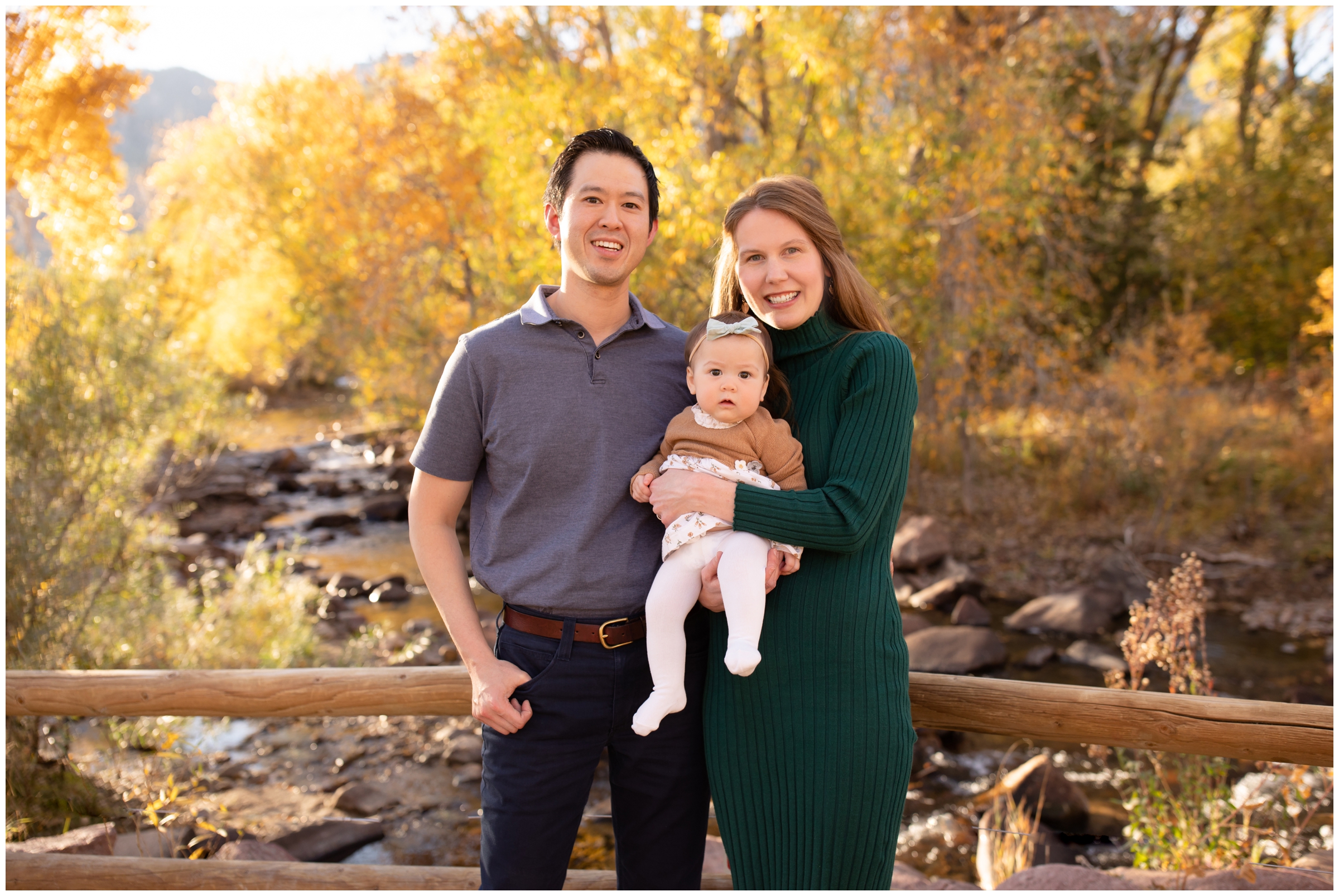 family posing in front of river during family photography session in Boulder Colorado