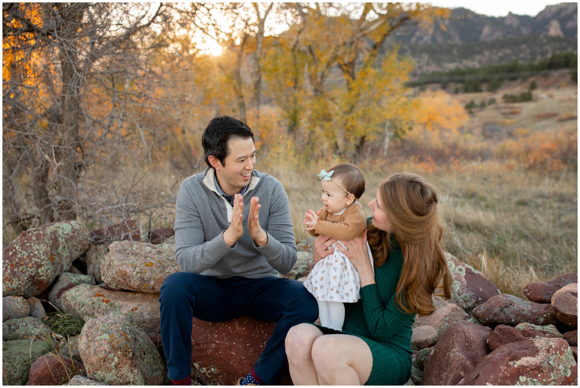 parents and daughter clapping during candid Boulder Colorado family pictures at South Mesa