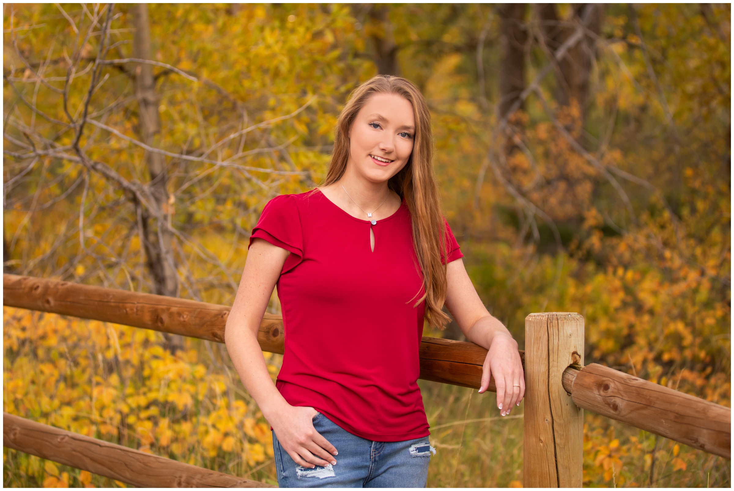 teen leaning on fence at South Mesa during Boulder senior photography portraits 