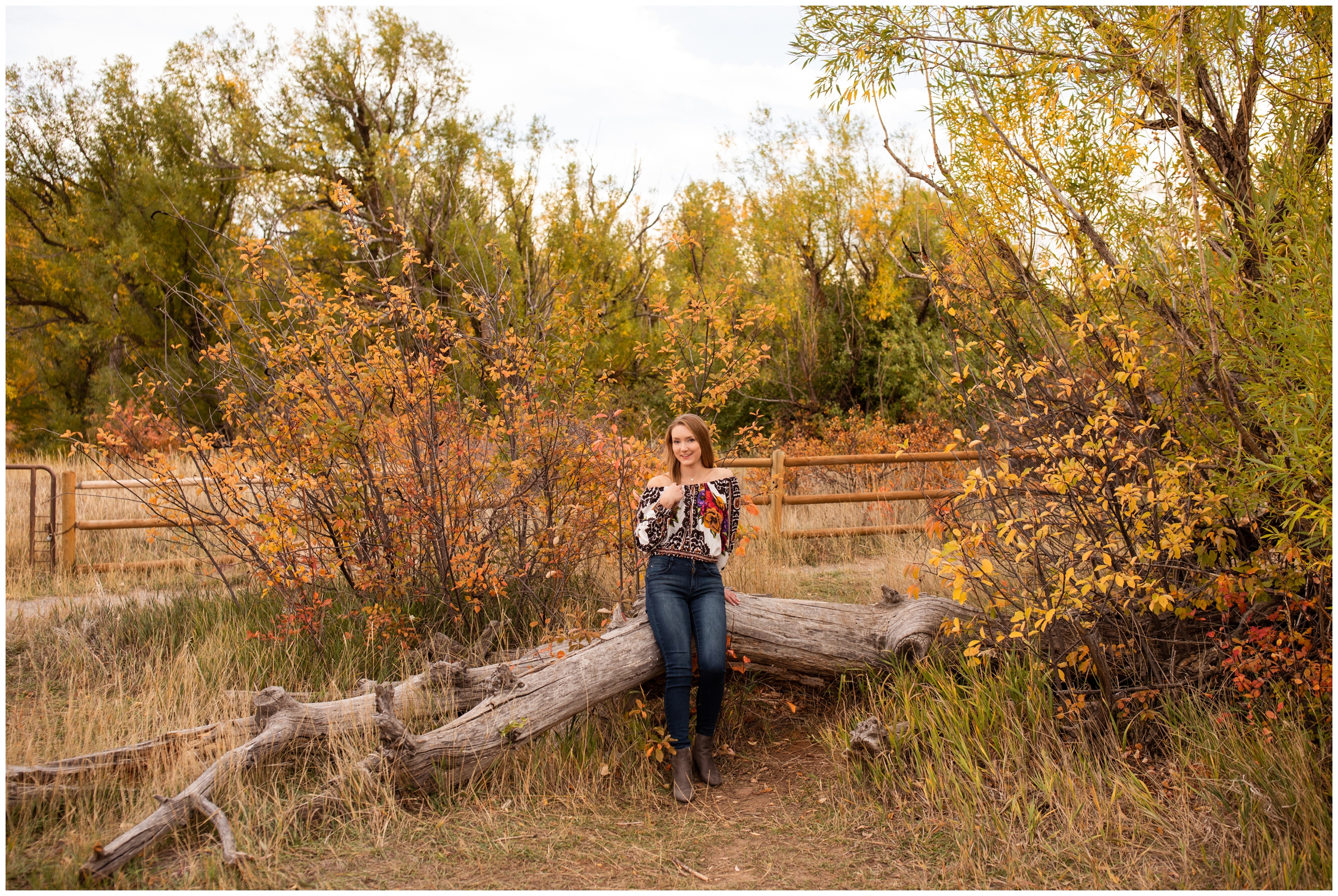 teen sitting on downed tree at South Mesa Trail in Boulder 