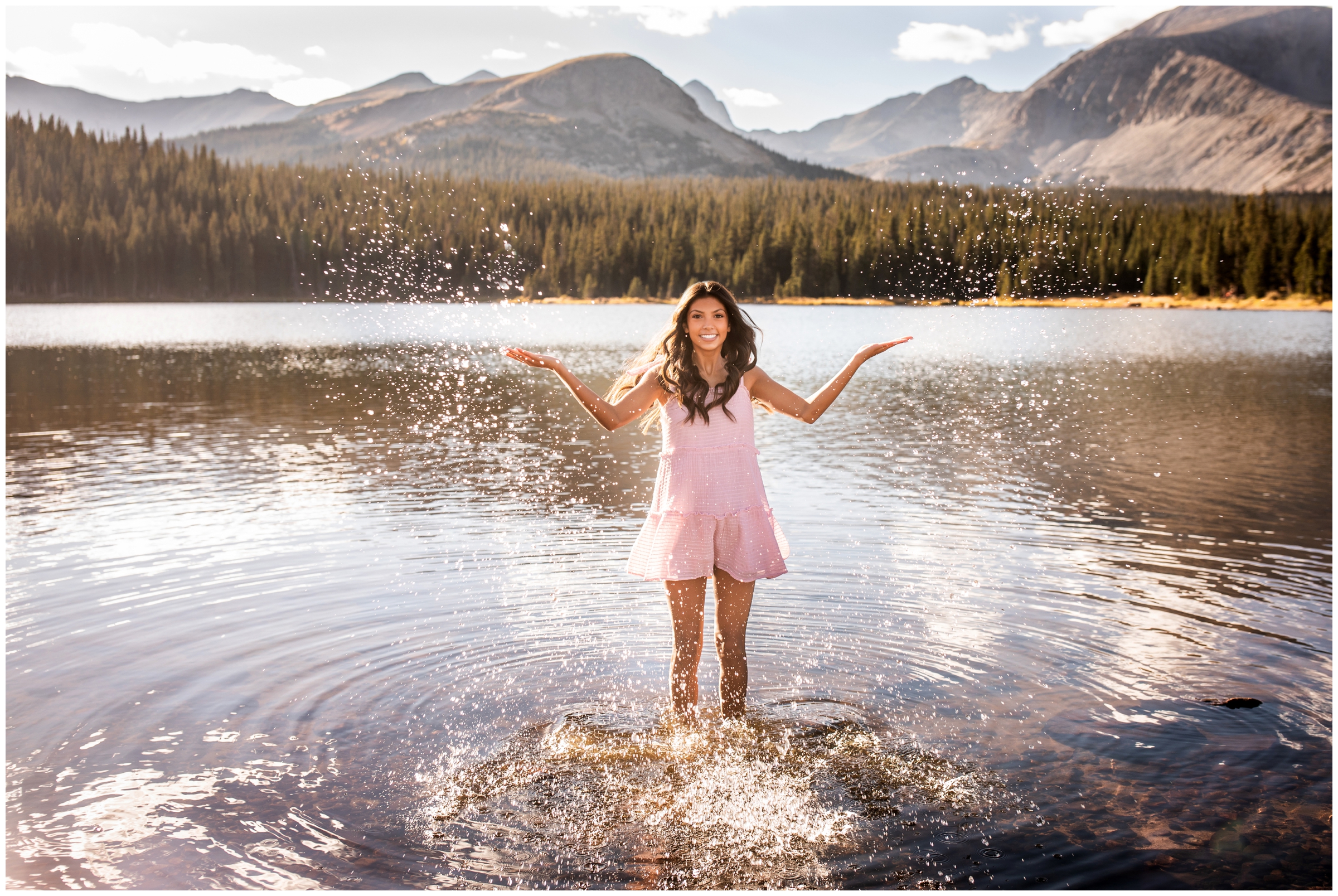 teen girl splashing in Brainard Lake during Colorado mountain senior pictures by Plum Pretty photos 