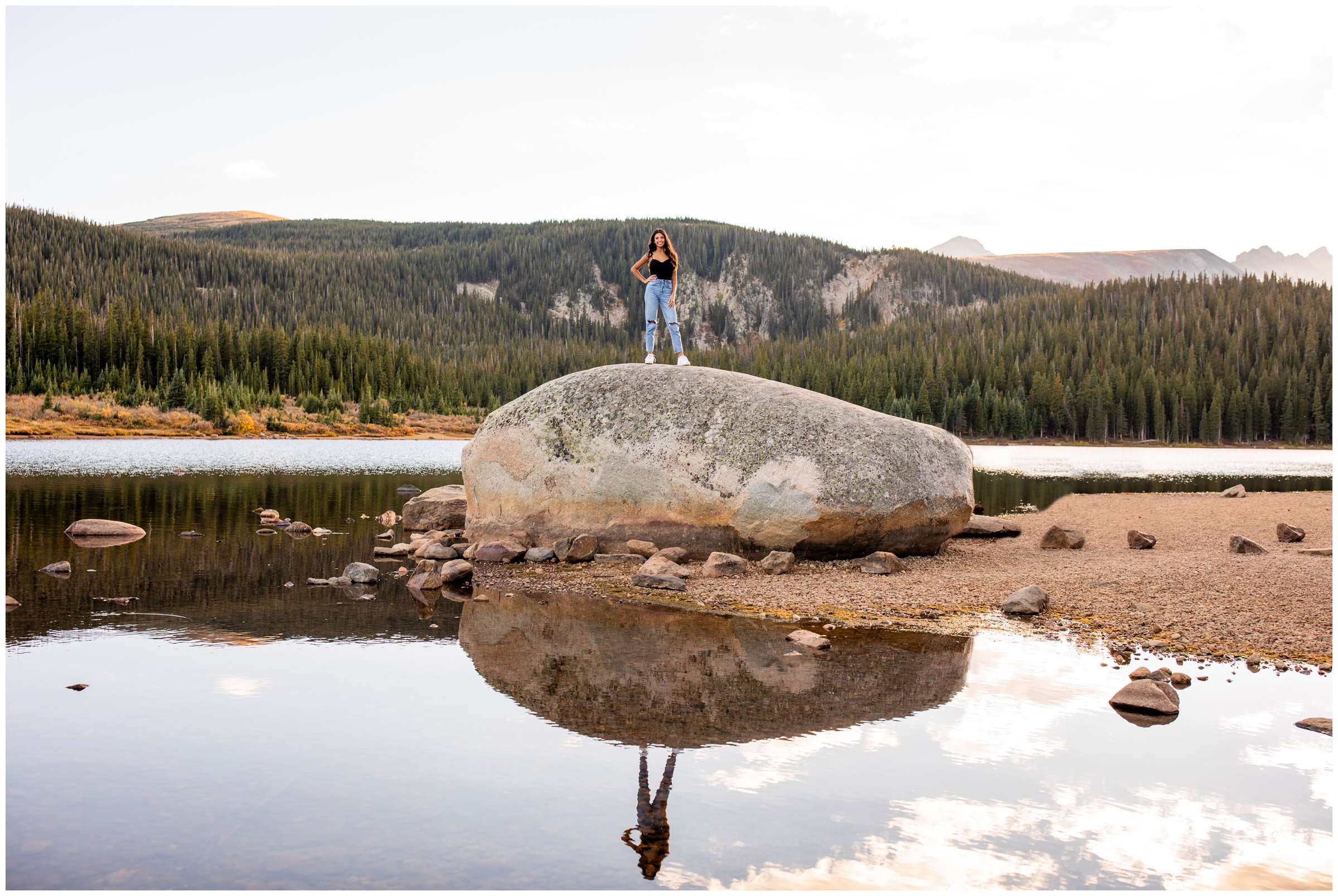 teen girl standing on giant boulder during Brainard Lake Colorado senior photos 