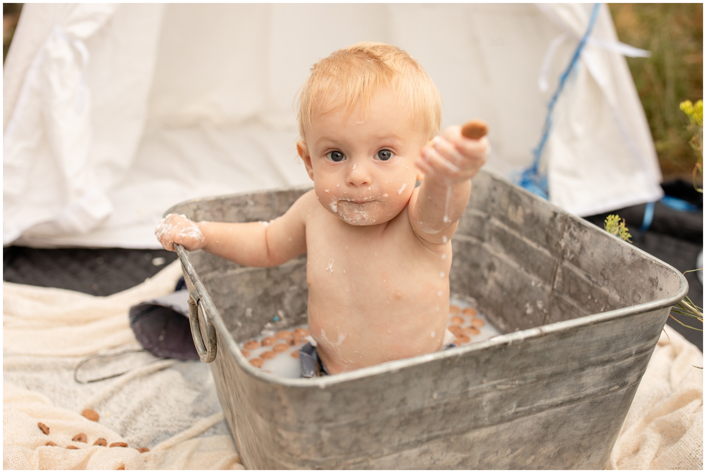 milk and cookies bath during first birthday cake smash session in Golden Colorado
