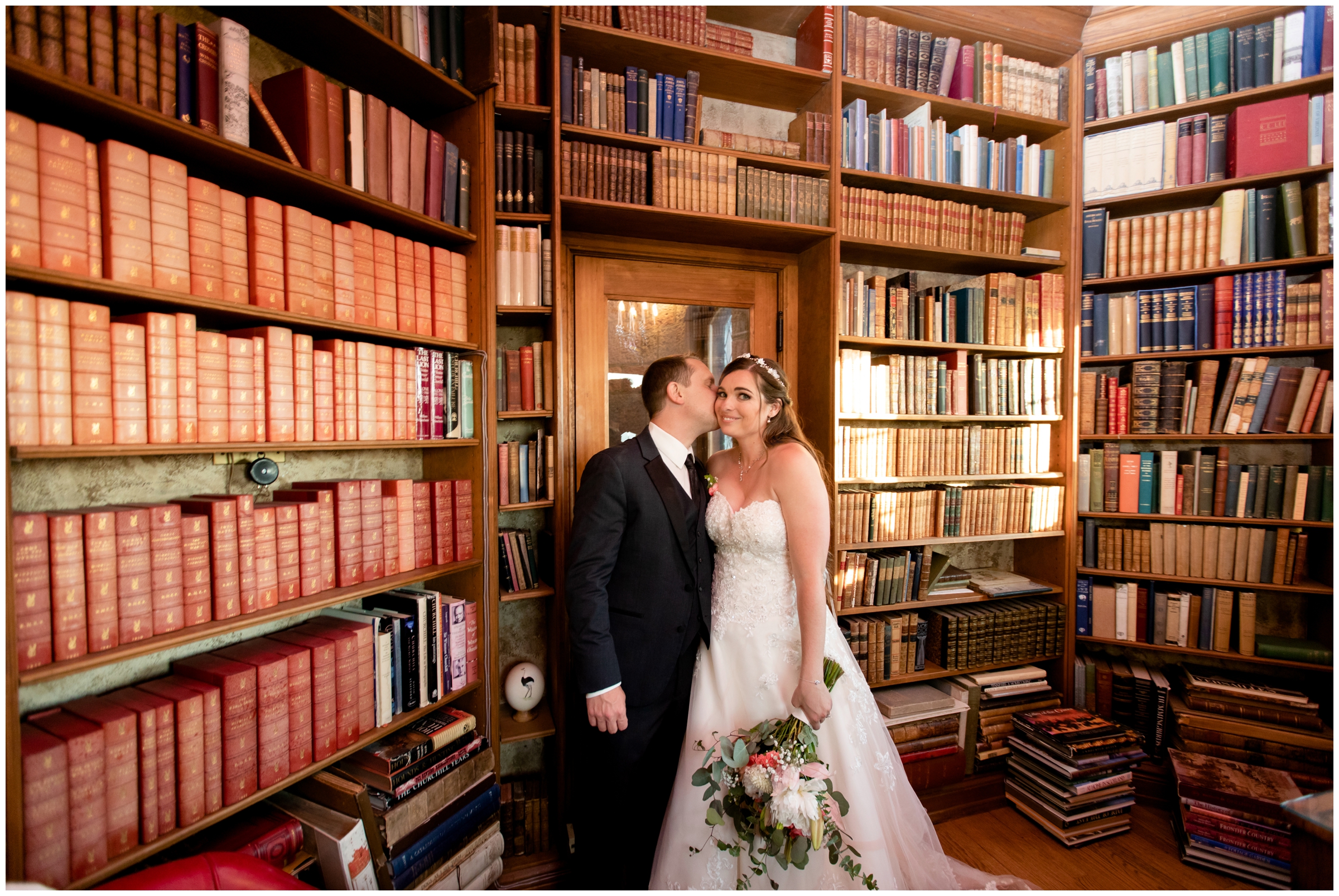 couple kissing in vintage library room at Colorado castle wedding at Cherokee Ranch