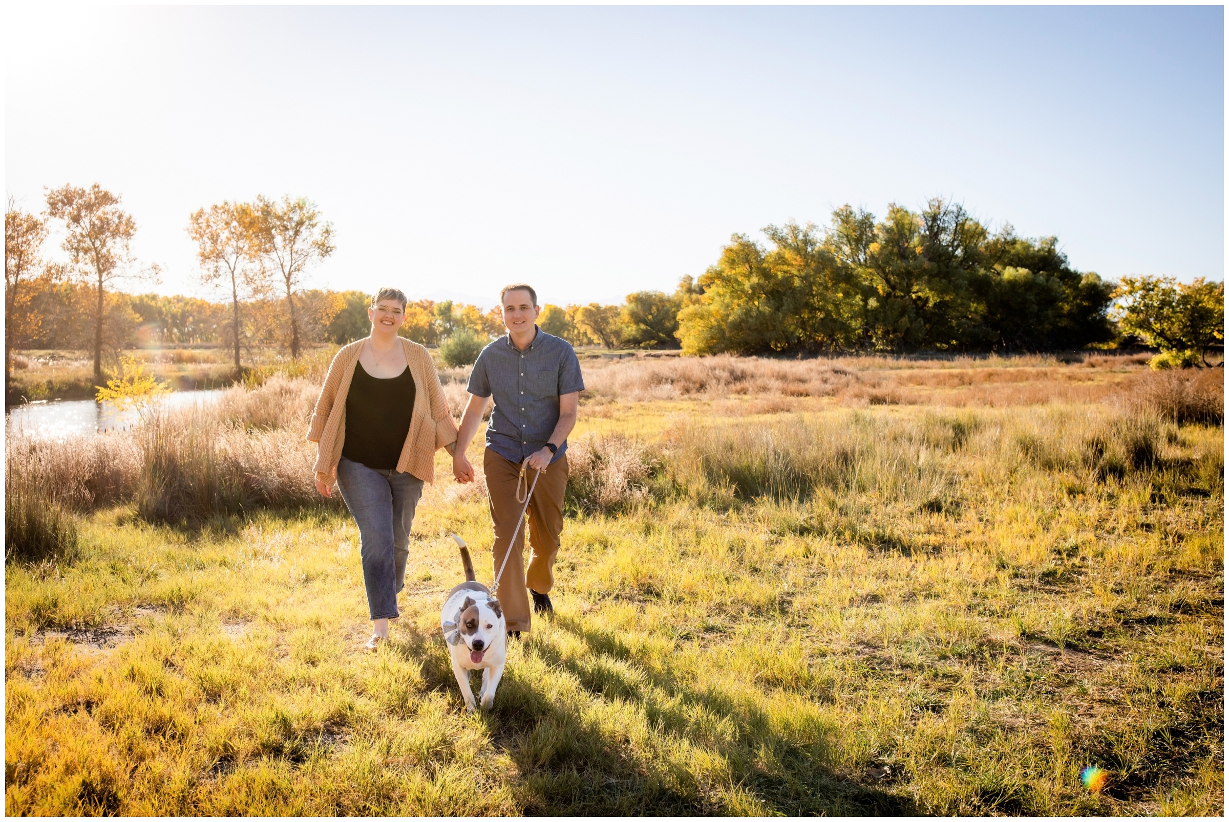 couple walking dog during photography session in Longmont Colorado