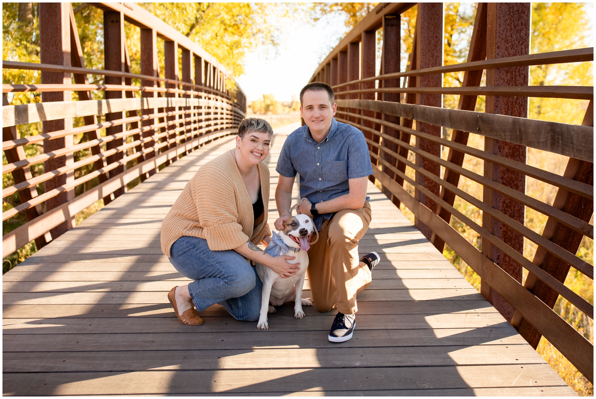 family posing on a bridge during Colorado couples photos with dog in Longmont
