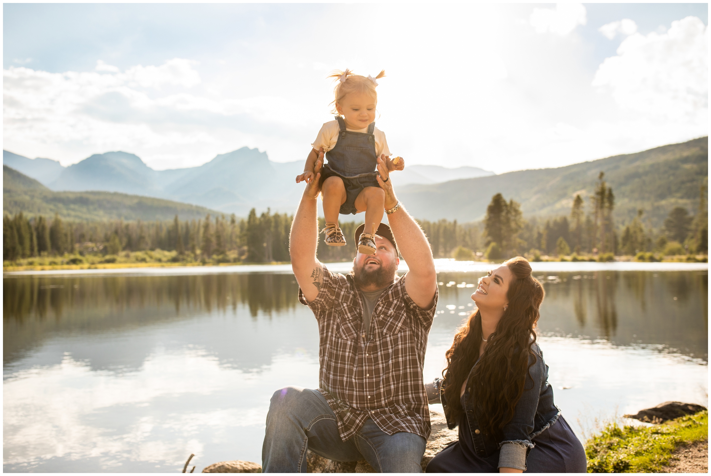 dad lifting daughter in the air during candid Colorado family photography session in Estes Park 