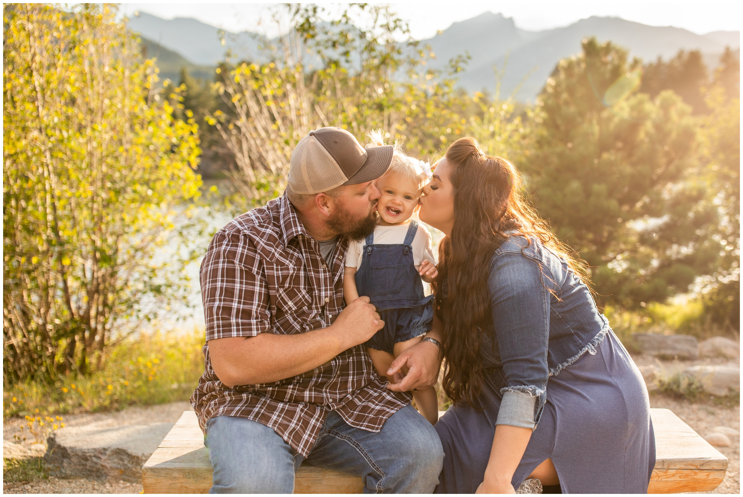 parents kissing daughter on cheeks during Estes Park Colorado family portraits 