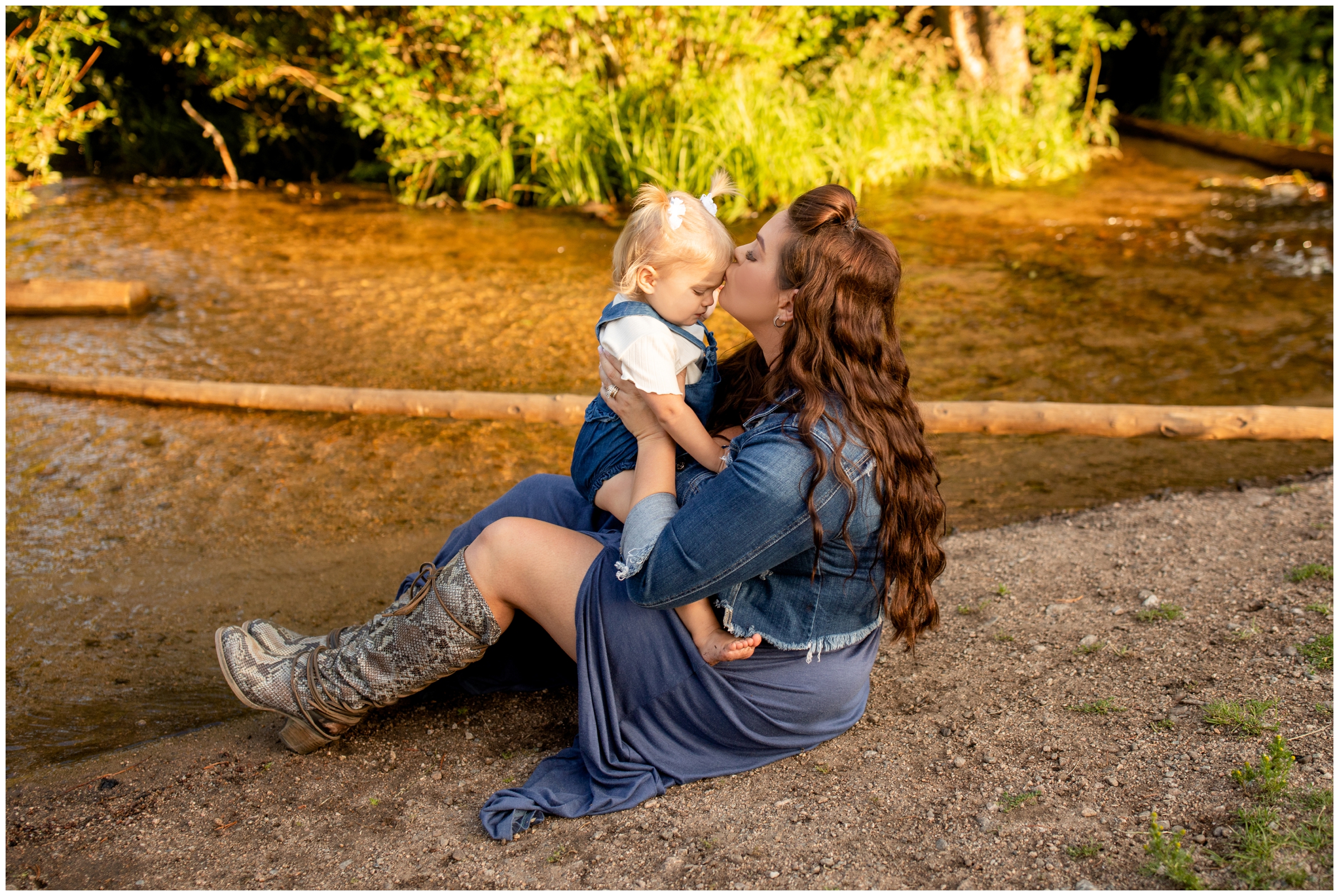 mom and daughter sitting next to the river during Estes Park family photos at Sprague Lake 